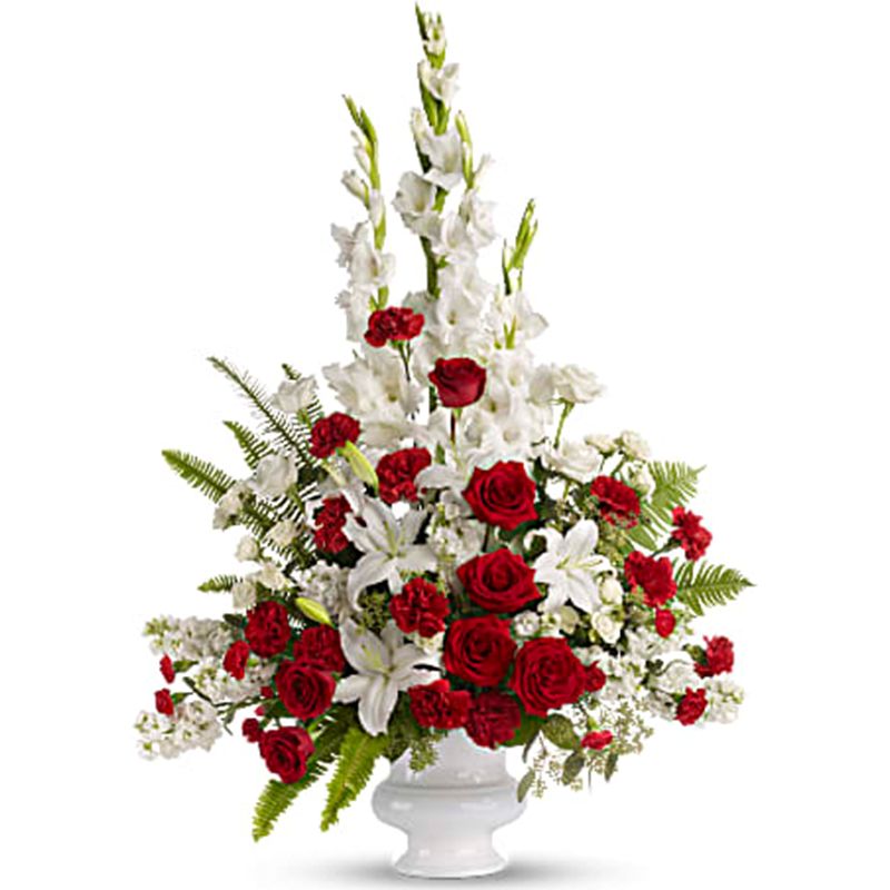 Memories to Treasure Urn - Honor your tender, treasured memories with these dramatic red and white sympathy flowers. Presented in a white pedestal vase, the red and white roses, white lilies and gladioli are a bold statement of eternal beauty and grace - perfect when you want to send a generous sympathy arrangement. Red and white roses are arranged with white oriental lilies, white gladioli, white stock and red carnations in a white designer urn. Seeded eucalyptus, sword fern and salal add elegant greenery. Orientation: One-Sided