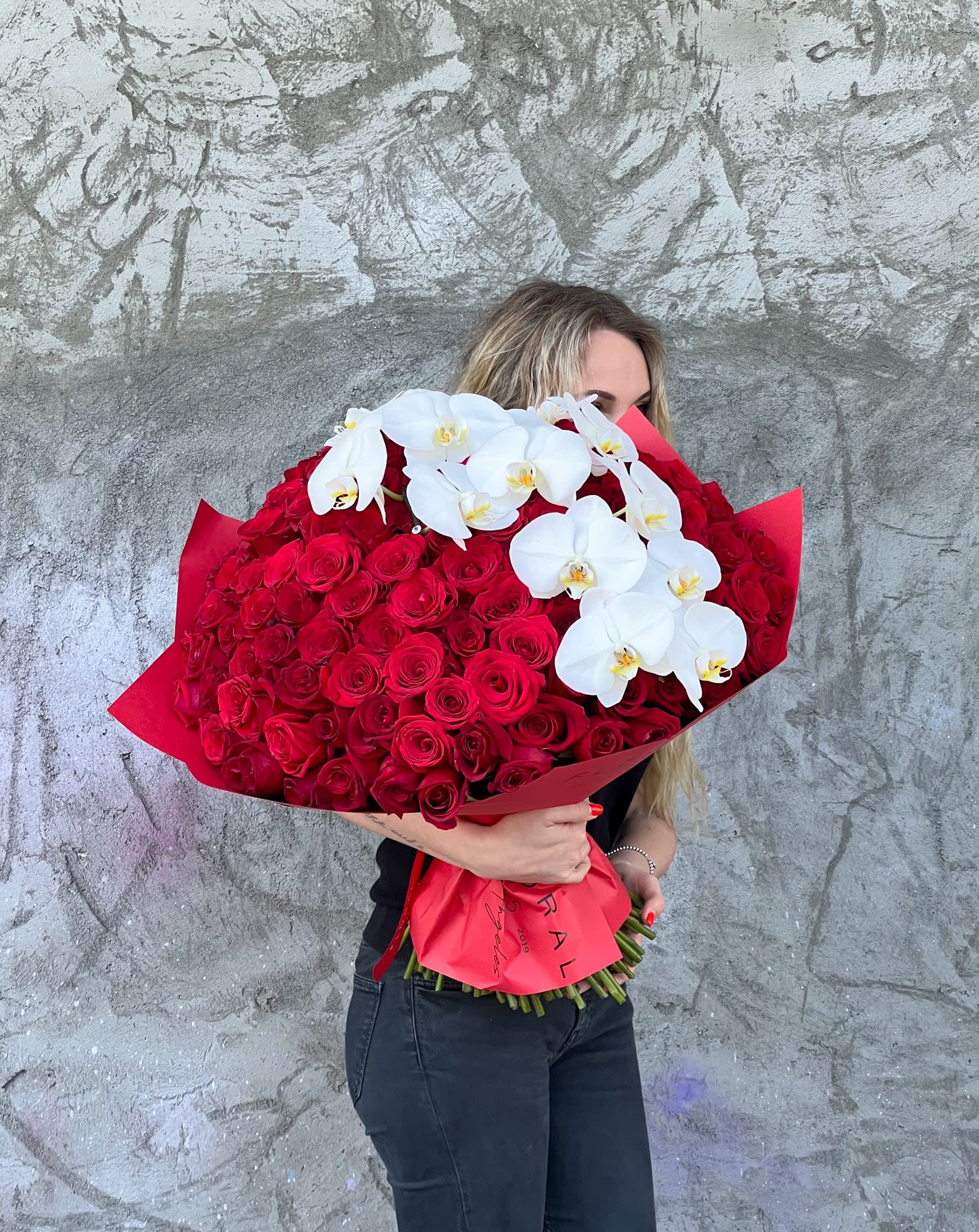 Crimson Grace Bouquet - Introducing Crimson Grace Bouquet, a stunning floral arrangement of velvety red roses and elegant white orchids. These fresh flowers blend passion and purity in perfect harmony. Order now for flower delivery in Houston, TX and make any moment unforgettable with timeless beauty!