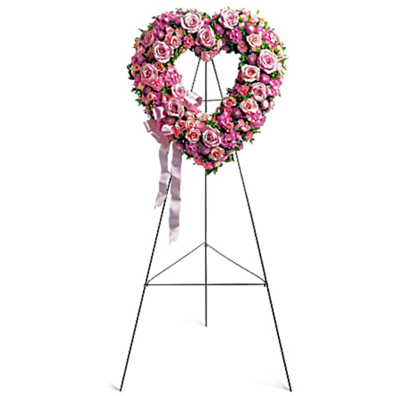 Rose Garden Heart Standing Spray - In the shape of a heart, and accented with a pink satin ribbon, this garden of delicate blooms is a tender and classic tribute to a precious life, and a cherished expression of love and sympathy. Beautiful flowers such as light pink roses, hydrangea and miniature carnations mix with lavender chrysanthemums on an open heart-shaped wreath. Orientation: One-Sided