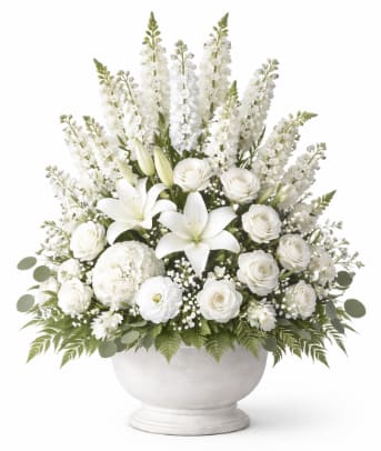 Funeral Traditional Piece - Traditional Funeral Arrangement – Customizable Tribute This traditional funeral arrangement is a timeless and respectful expression of sympathy, designed to honor a life beautifully remembered. Created in a classic paper mâché or plastic urn-style container, this piece features a balanced mix of fresh seasonal flowers and lush greenery, arranged with care and elegance.  Each arrangement is fully customizable to reflect personal preferences, including color palette, flower selection, and overall style. From soft and serene to bright and celebratory, our designers will thoughtfully tailor the design to suit your wishes. Please include all specific requests in the Instructions section, such as preferred colors, meaningful flowers, or the tone you envision, to help us create a tribute that feels personal and heartfelt.