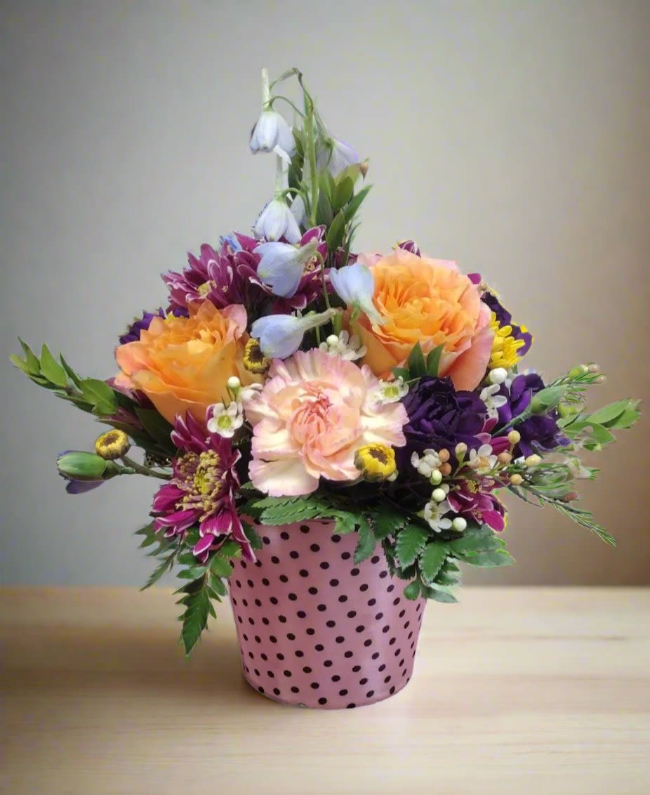 Pail of Posies - Pail of Posies is a charming floral arrangement presented in a delightful pail shaped container, perfect for brightening any space. This vibrant collection of fresh flowers can be customized based on your color preferences noted in the order, ensuring a personal touch.  If no specific colors are requested, our skilled designers will create a stunning arrangement using their expertise to select the best seasonal blooms. Each design is unique, reflecting the beauty of nature, and may include color substitutions based on availability.