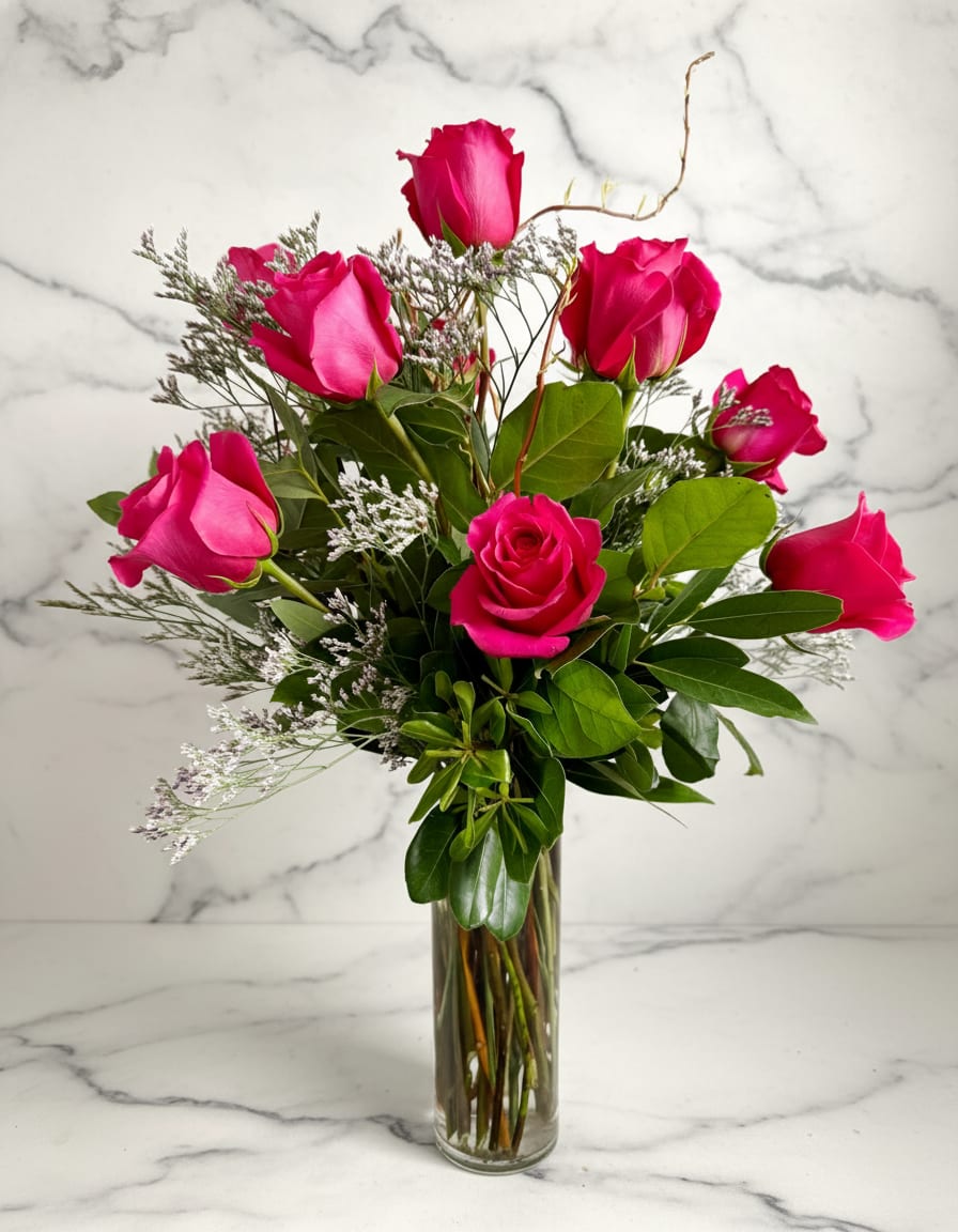 Valentine’s Day Pink Rose Vase Arrangement - Standard price is- One dozen roses Deluxe Price is- Two dozen roses Premium Price is- Three dozen roses Hot pink roses are arranged in a tall cylinder vase with greens and filler.   Valentine's Day Delivery- We cannot guarantee delivery times over the Feb 13/14th. We will not be calling recipients before we make deliveries. We will ring the bell on arrival and if no one answers we will call or send them a text with a picture of the location of the arrangement. 