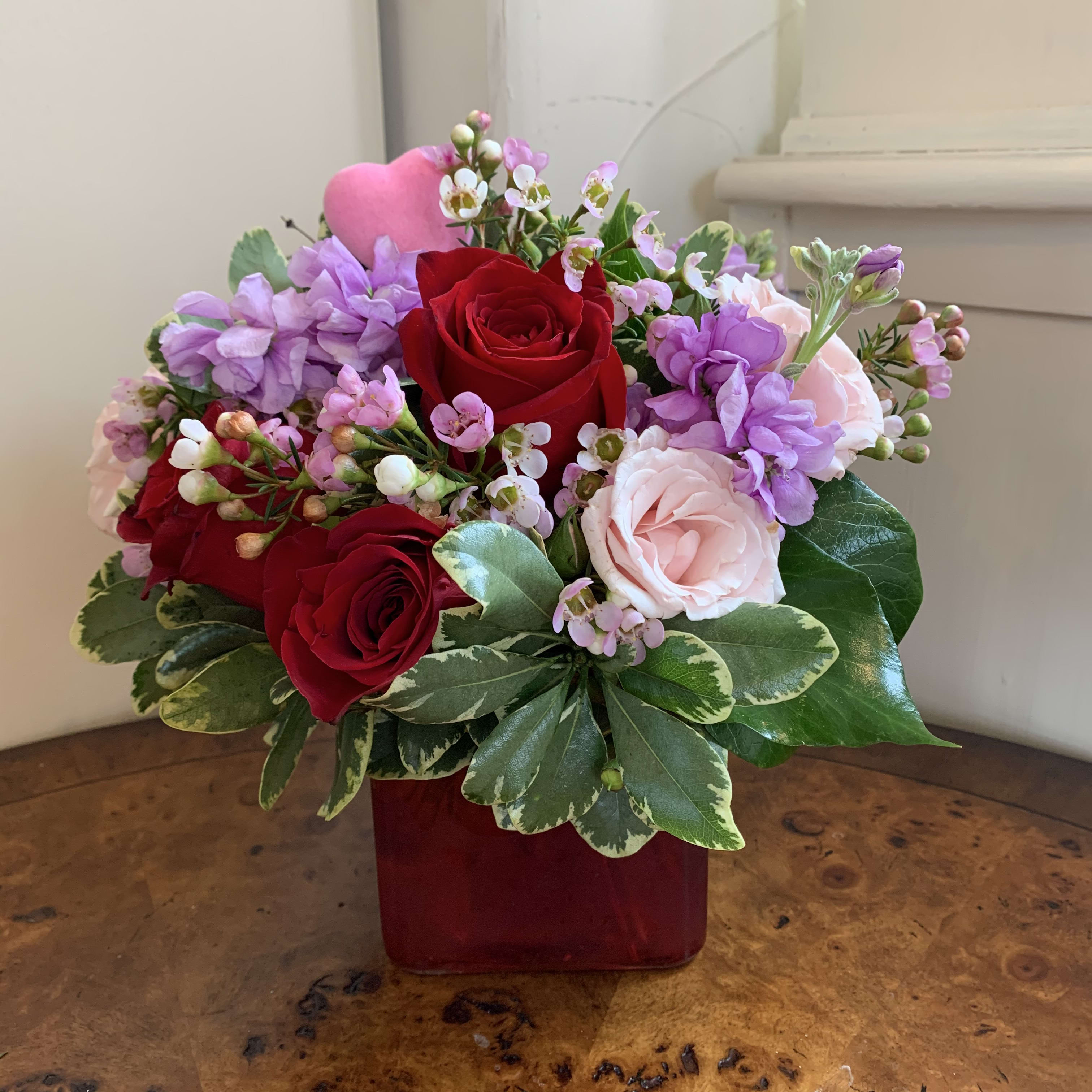Love and Lavender - Pink and red roses and lavender fragrant stock with complimenting filler flowers and a mini pink heart. Aproximately 7" high and 7" wide