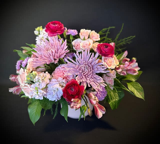 &amp; Juliet - “I kissed a girl and I liked it”  This arrangement is sweet and timeless, featuring light purple and pink blooms, complemented by delicate light pink spray roses and striking ranunculus. Much like the love between Juliet, it's a classic expression of romance—perfect for showing your special someone just how much they mean to you.