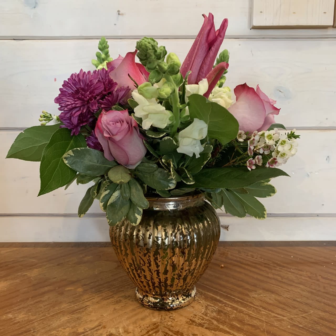 Sweet Nothings Bouquet - Lavender roses, chrysanthemums, white snaps and pink lily bloom arranged in mercury urn with seasonal filler flower. Approximately 10in tall and 10in wide.  