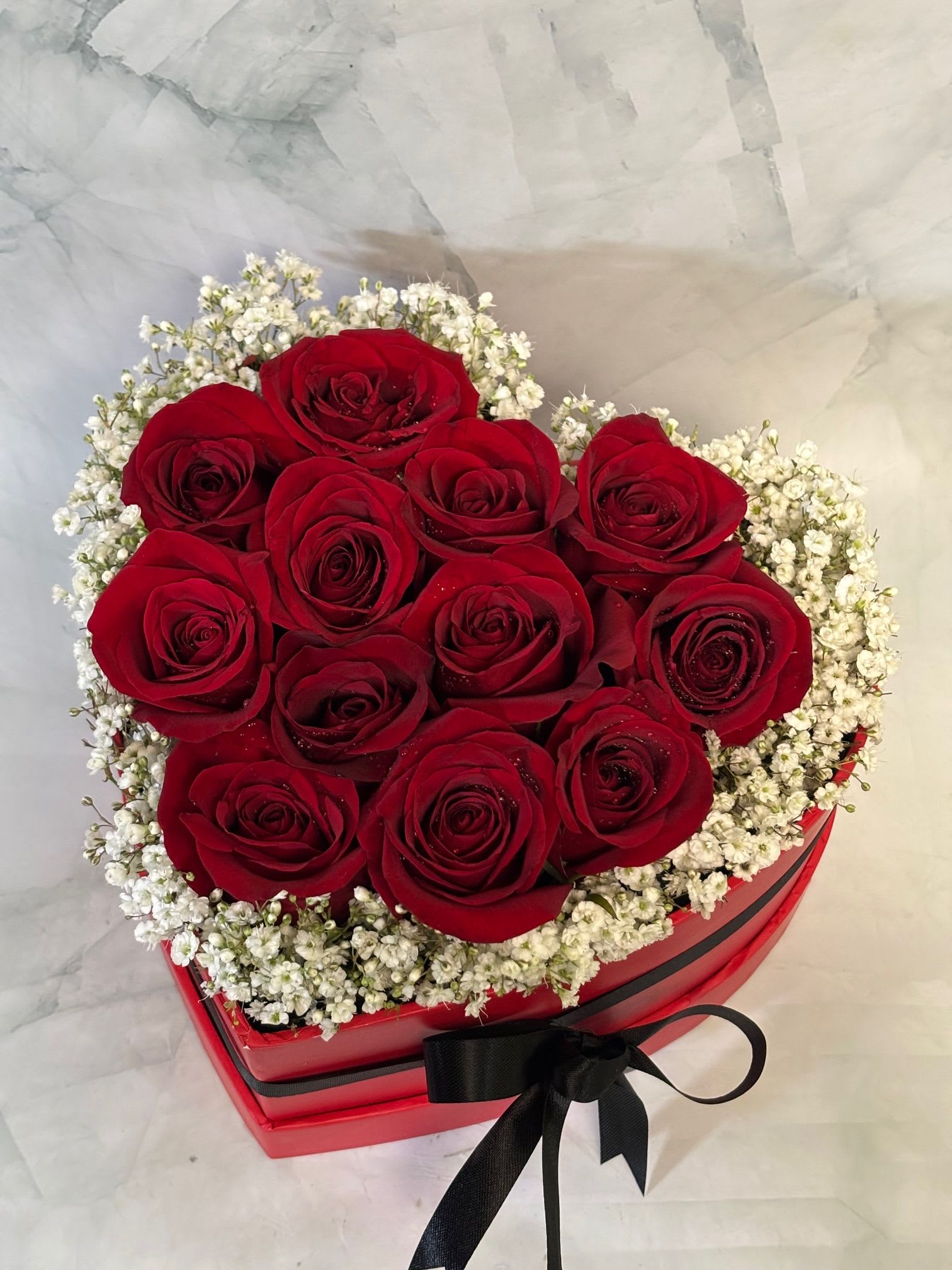 Dozen Red Roses Heart Shaped Gift Box - This arrangement is full of 12 fresh red roses that are designed in the shape of a heart. 
