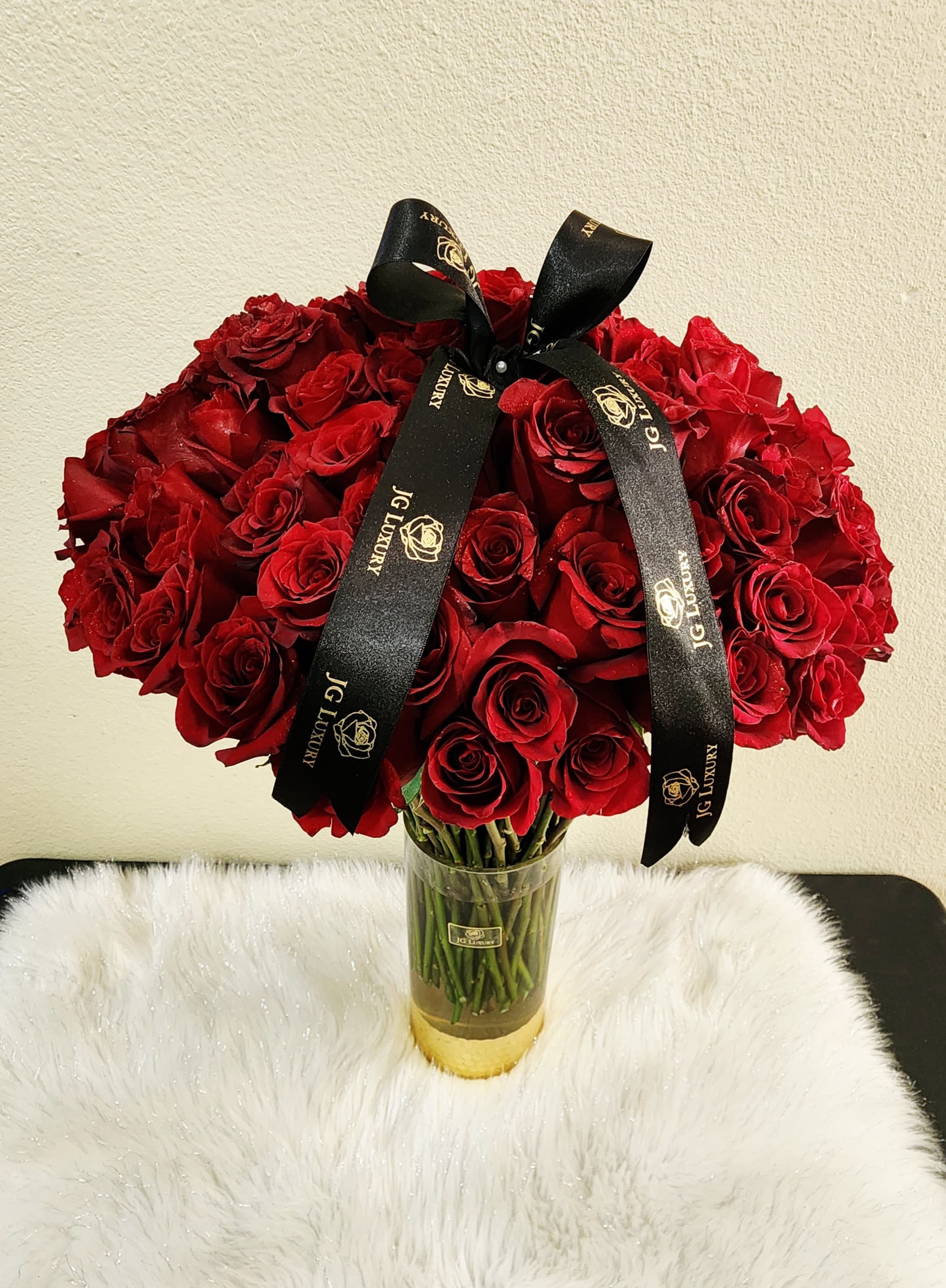 Devotion - A breathtaking arrangement of 50 premium red roses in a clear gold dipped glass vase. Elegant and timeless, perfect for any occasion you choose to celebrate, the moment is yours to define.