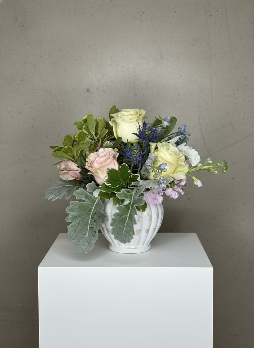 Sugarplum Fariy - If you enjoy pastel, muted, beautiful colors then this arrangement is for you!  The perfect blend of whites, pinks, with a touch of blue and a variety of greens. Perfect for any occasion.  Order today for delivery or pickup!
