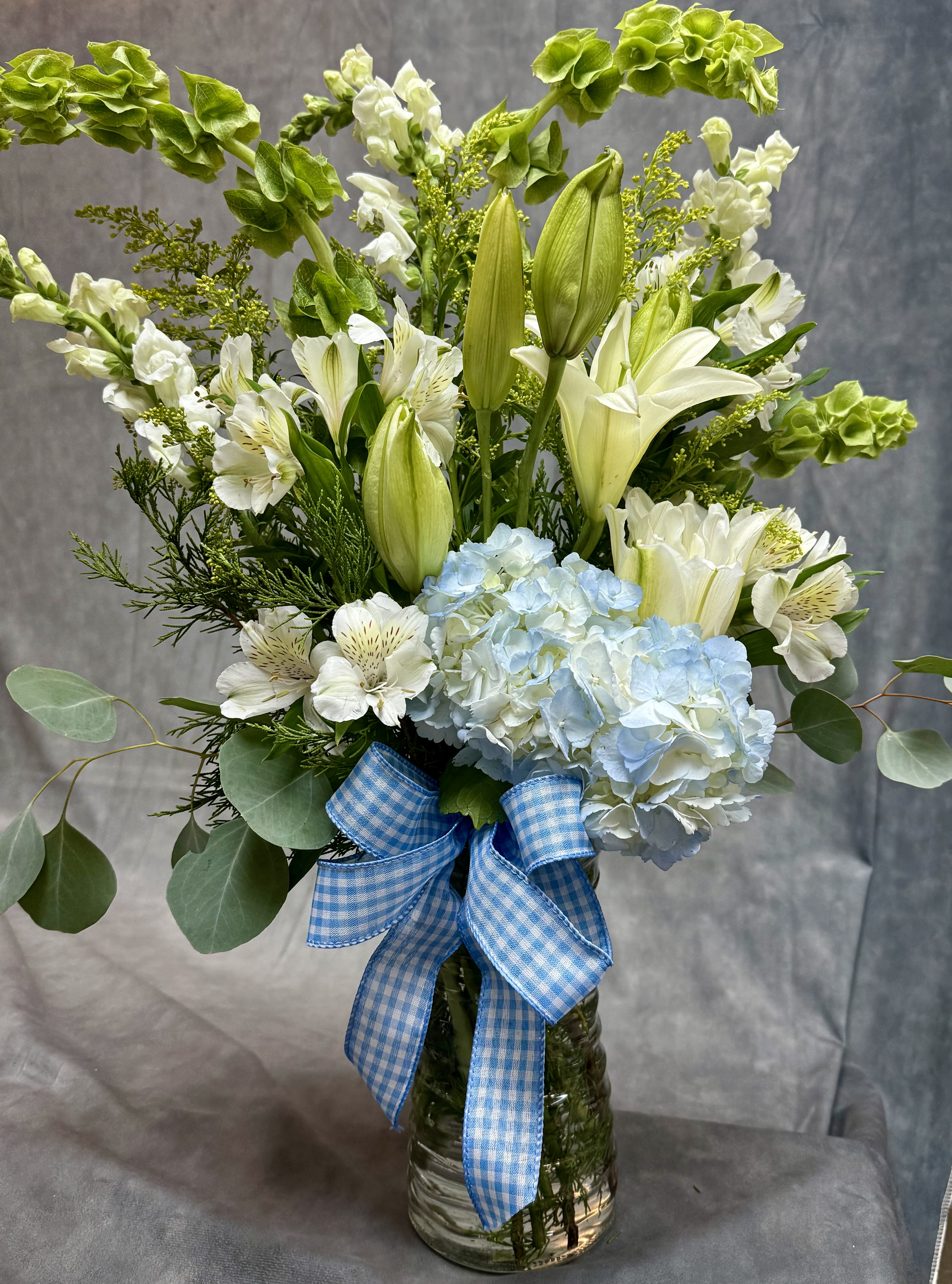 Blue Hue  - introducing Our New Design Blue Hue, beautifully arranged with lilies, hydrangea, delphinium, Alstroemeria, fillers and greenery