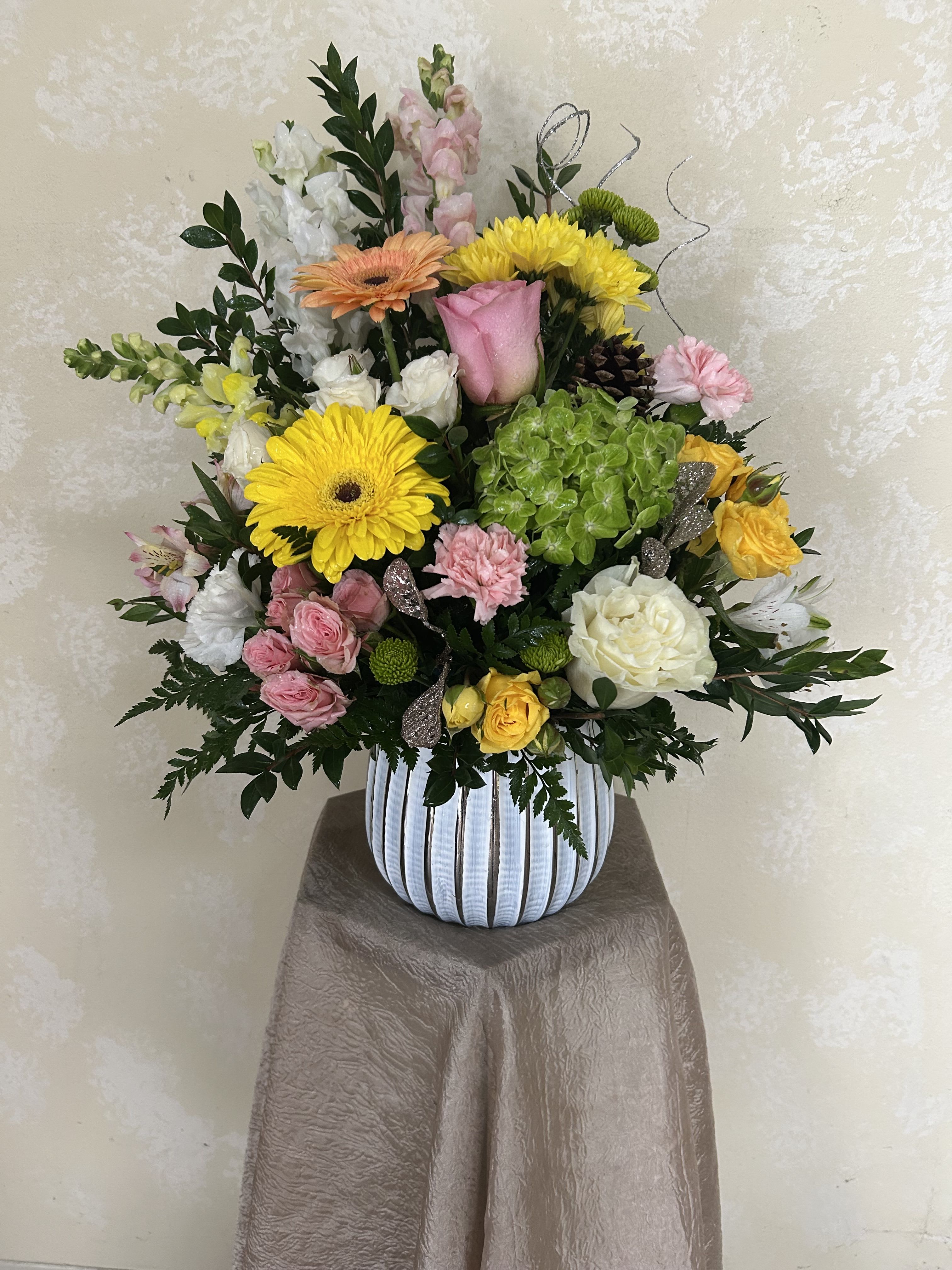 The Anastasia - An elegant, colorful mix of pastels. In a beautiful white and silver keepsake vase.