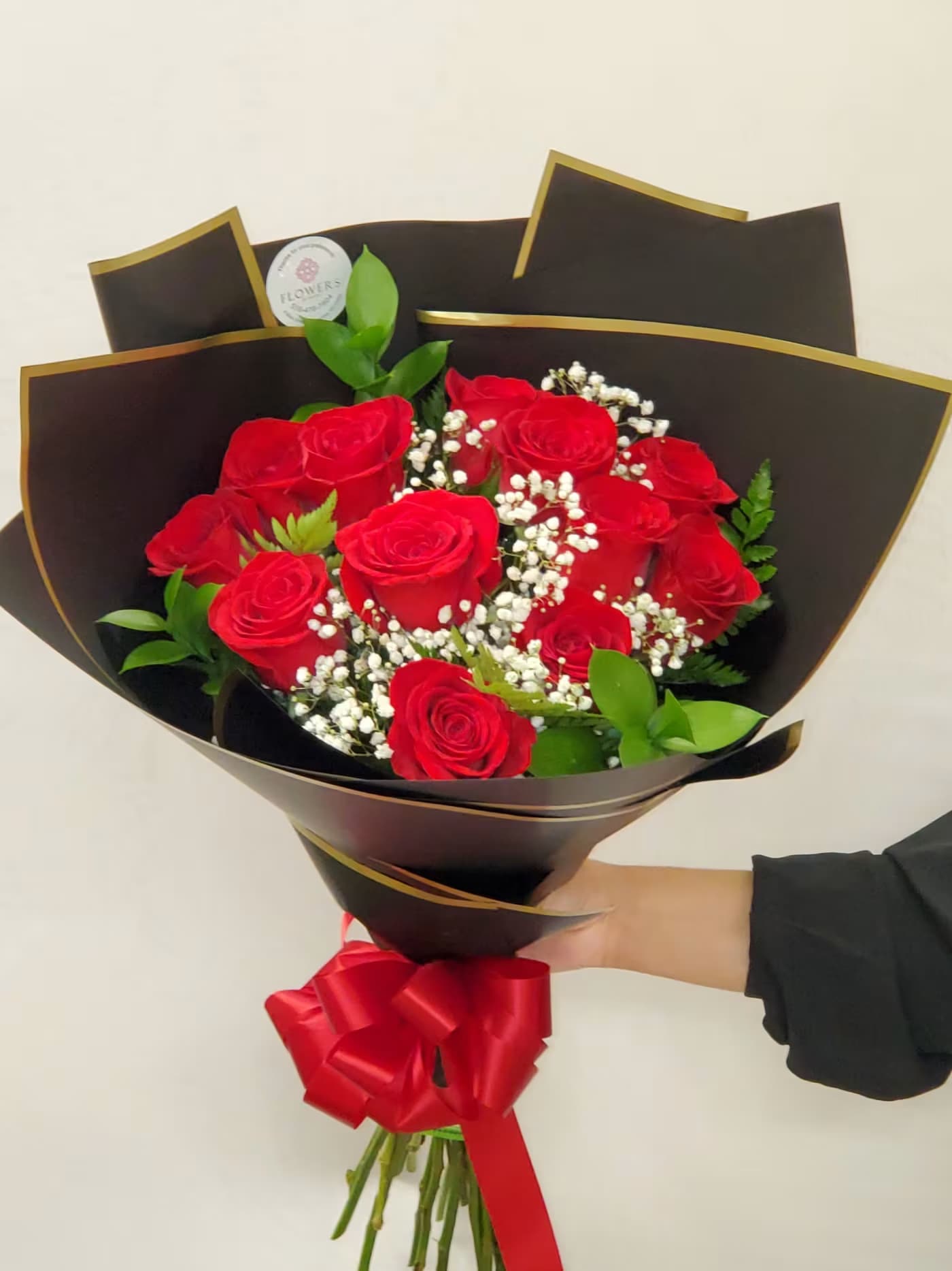 12 roses with black wrap - Standard: 12 red roses with black wrap Deluxe: 18 roses Premium: 24 roses