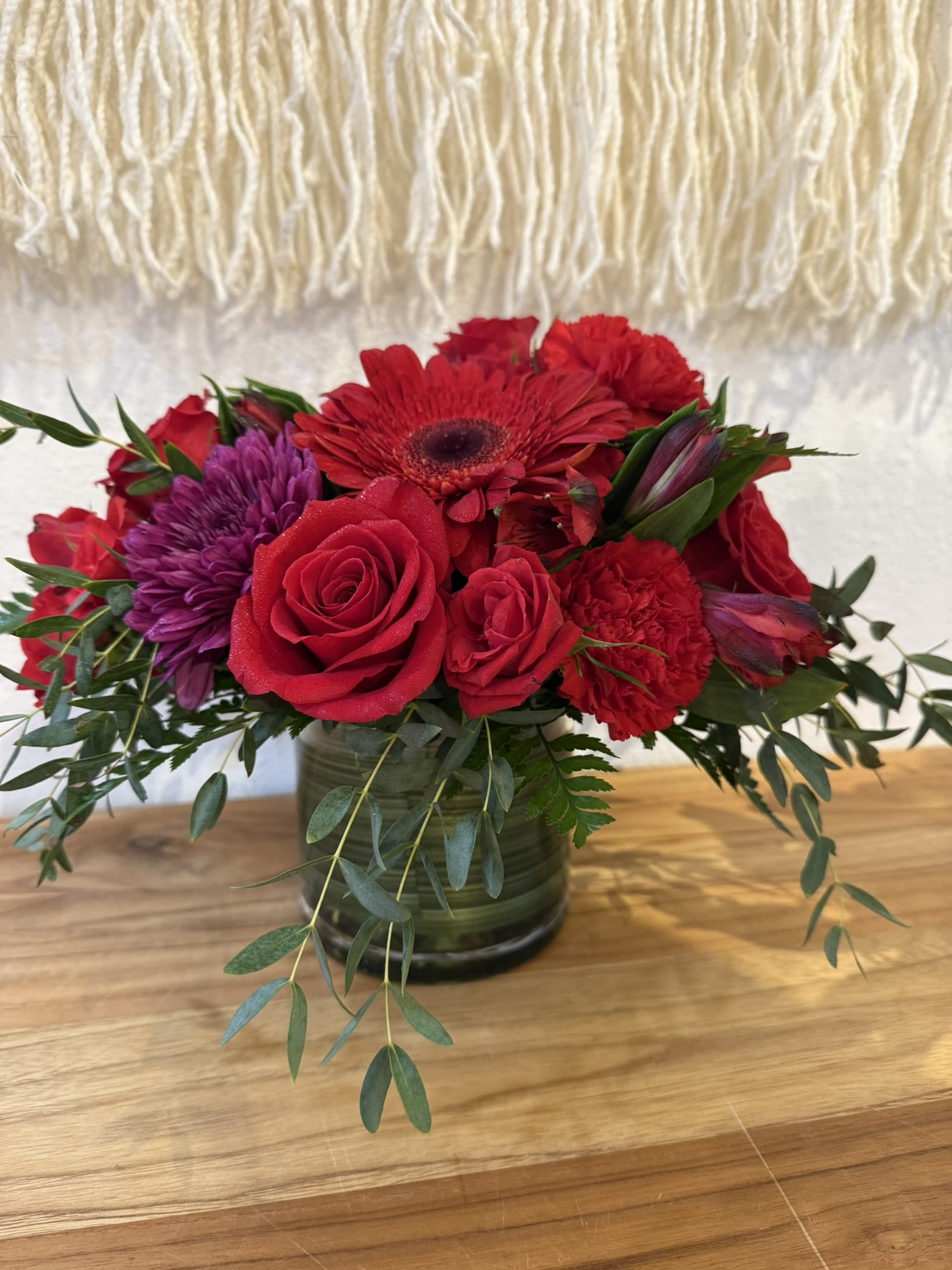 Classic Red Elegance - Deep red florals arranged in a vase to create a powerful and elegant statement, perfect for meaningful moments and celebrations.