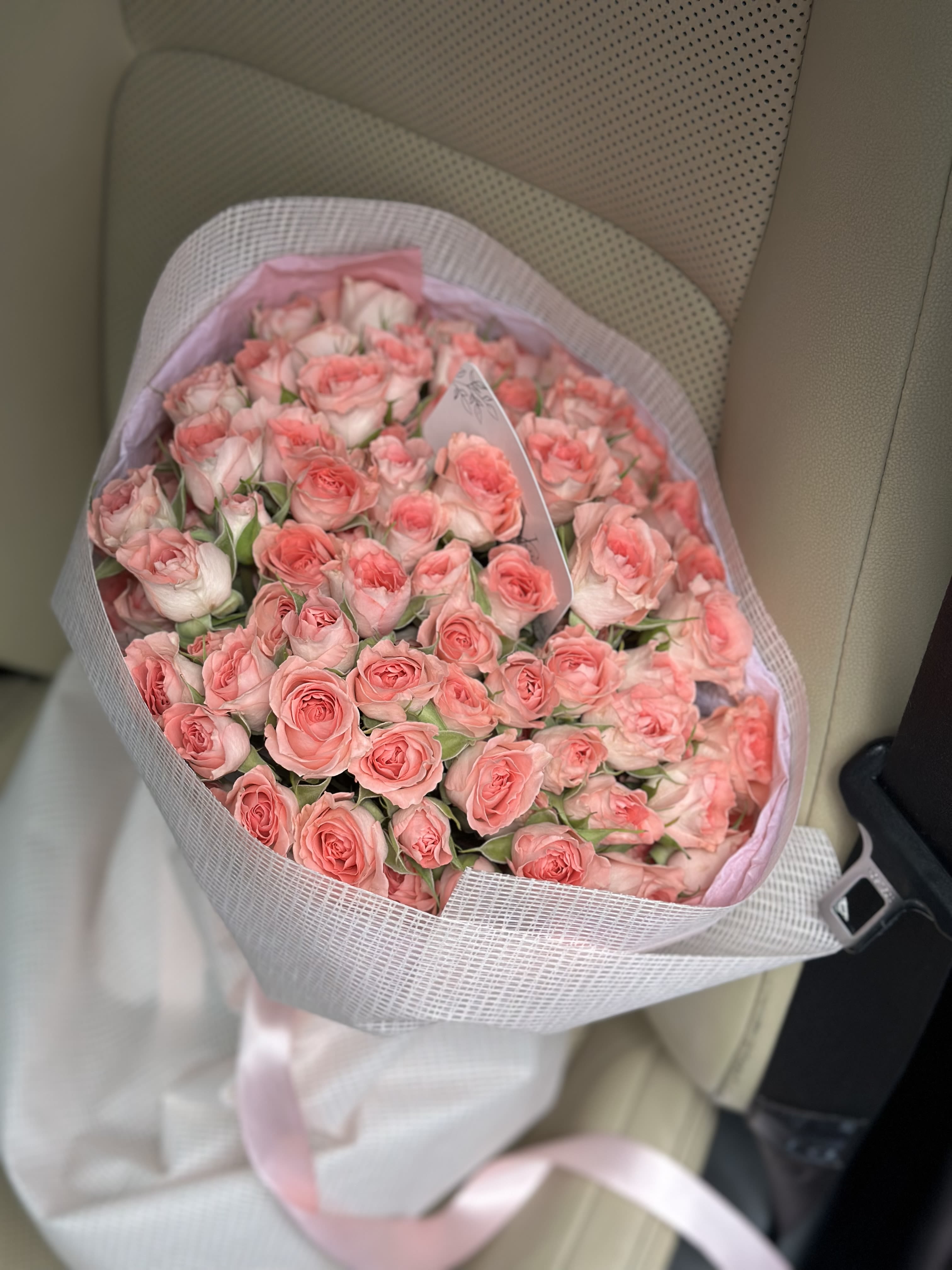 Coral Dreams - A lush bouquet of delicate spray roses in soft peach and blush tones. Wrapped in an elegant fabric and tied with a satin ribbon, it radiates tenderness and charm. A perfect gift to express admiration, affection, or to brighten someone’s day with pure beauty.