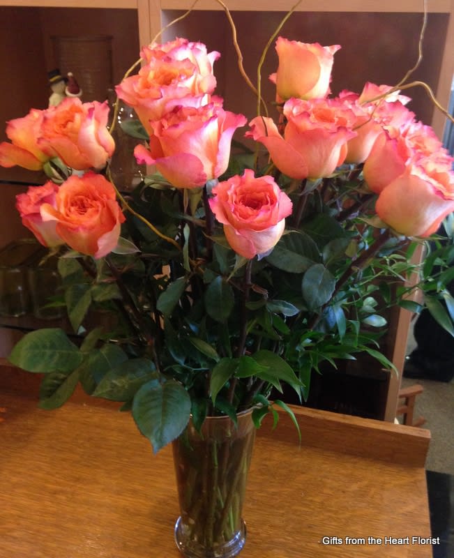 PERFECTION $100/150/200 - Send your love with these spectacular roses called Free Spirit, in a tall traditional design.  The color is a cross of deep peach and pink.  Regular price is for one dozen rose, deluxe for eighteen roses and premium for two dozen roses.  Pictured at regular price for one dozen.   Don't forget  to add a special finishing touch of chocolate, a fragrant candle, teddy bear or heart shaped Vintage brooch. 