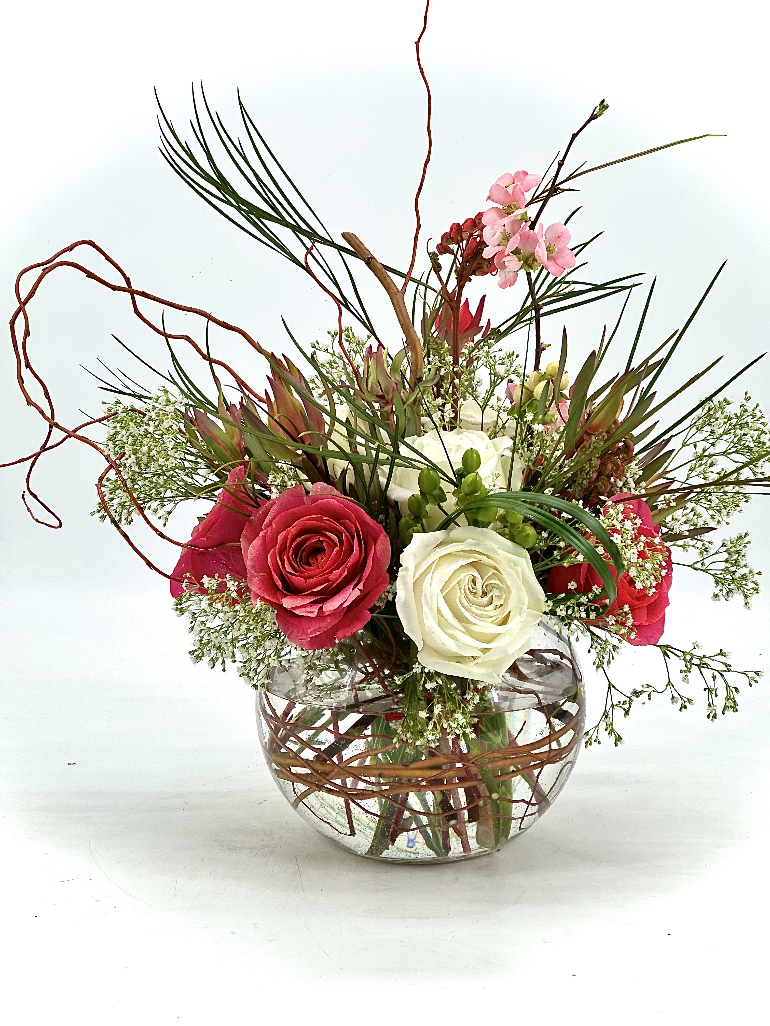 The Signature Globe  - A beautiful handcrafted design round globe floral arrangement, designed  with balance ,symmetry ,and modern elegance in mind .Premium roses in soft ivory and rich blush tones are thoughtfully arranged in a perfectly rounded silhouette with ,accented with delicate seasonal blooms, natural branches  and refined greenery for subtle texture and depth.Each piece is designed to feel intentional ,graceful and effortlessly in any space for any occasions.  Deluxe and Premium upgrades is added more premium blooms for a fuller and more luxury presentation.