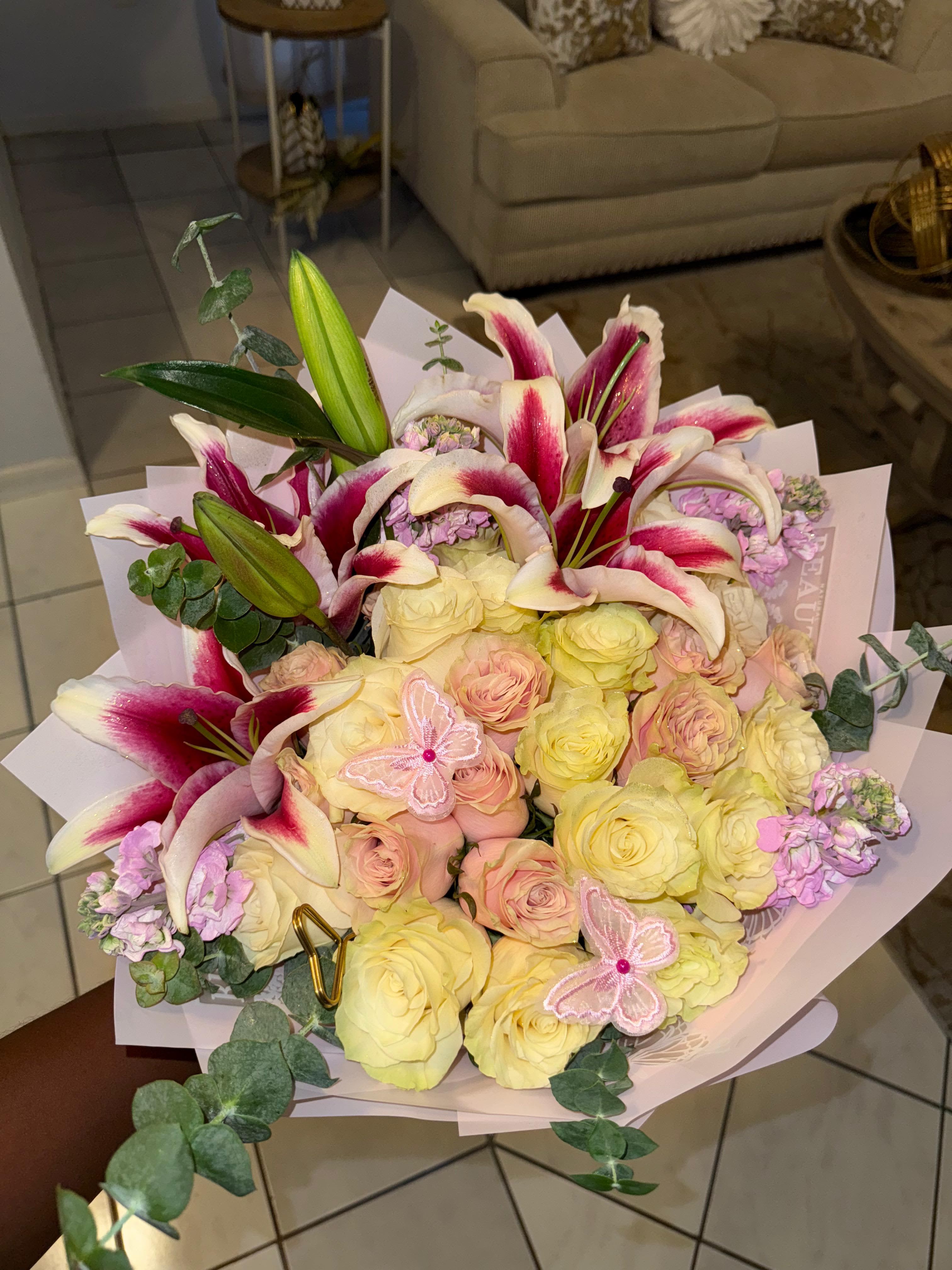 Annika - A dreamy confection of pink and white: lush roses meet vibrant stargazer lilies, all tied up with a sweet butterfly kiss. Absolutely gorgeous! 
