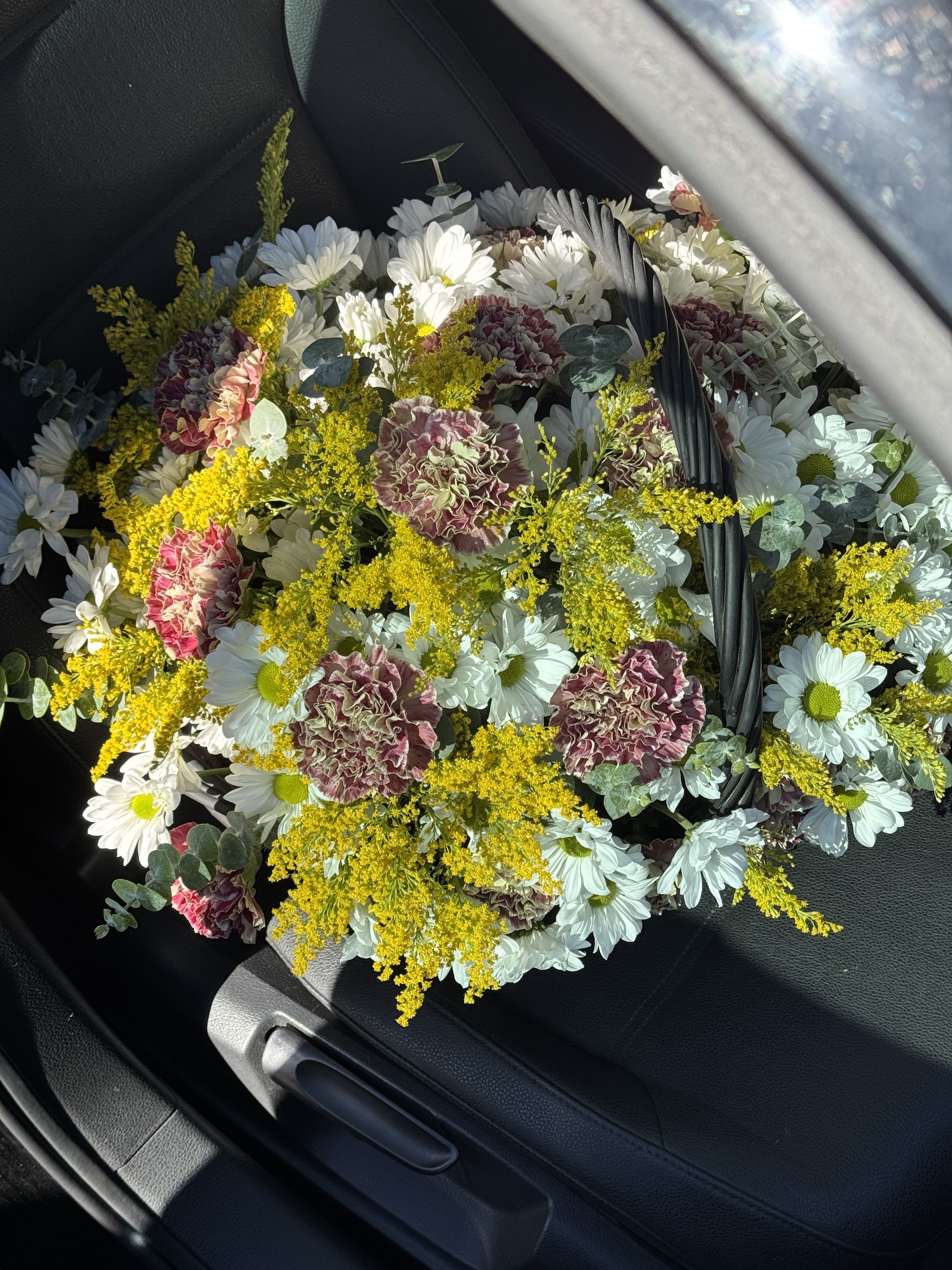 Wildflowers in a Basket — The Breath of Nature and Simplicity - There’s something truly enchanting about wildflowers. They don’t boast of luxury, they don’t need perfect symmetry, and they don’t compete for attention. Their beauty lies in their naturalness — in the soft touch of the wind, in the warmth of the sun, and in the memories of long summer days when nature feels alive and free.  A basket filled with wildflowers is like bringing a piece of the meadow into your home. Such an arrangement radiates warmth, coziness, and sincerity. It’s made for those who appreciate authenticity, soft natural tones, and effortless charm.  In our wildflower basket, you’ll find a delicate mix of blooms that look as if they were just gathered from a morning field. Gentle daisies, blue cornflowers, gypsophila, lavender, bellflowers, or fragrant herbs — each one adds its own note: freshness, tenderness, or a hint of nostalgia. Together, they create a harmonious melody of colors and scents.  The natural wicker basket complements the flowers perfectly, emphasizing their rustic character. It’s not just a bouquet — it’s a story about simplicity, lightness, and the beauty that lives in the small things.  Whether you gift it to someone special or keep it for yourself, a wildflower basket will fill any space with peace and joy. It’s a gentle reminder that true beauty doesn’t need to be perfect — it only needs to be real.