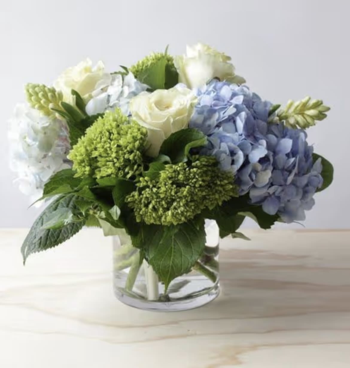 seaside blues  - blue &amp; green hydrangea, white roses and greens in a glass cylinder or cube 