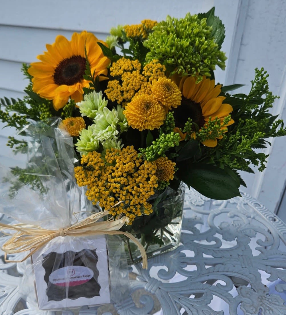 Sunflower deal of the day with fudge - Sunflowers, yarrow, daisies, yellow button poms and green hydrangea arranged in a vase with Ralphina's homemade fudge