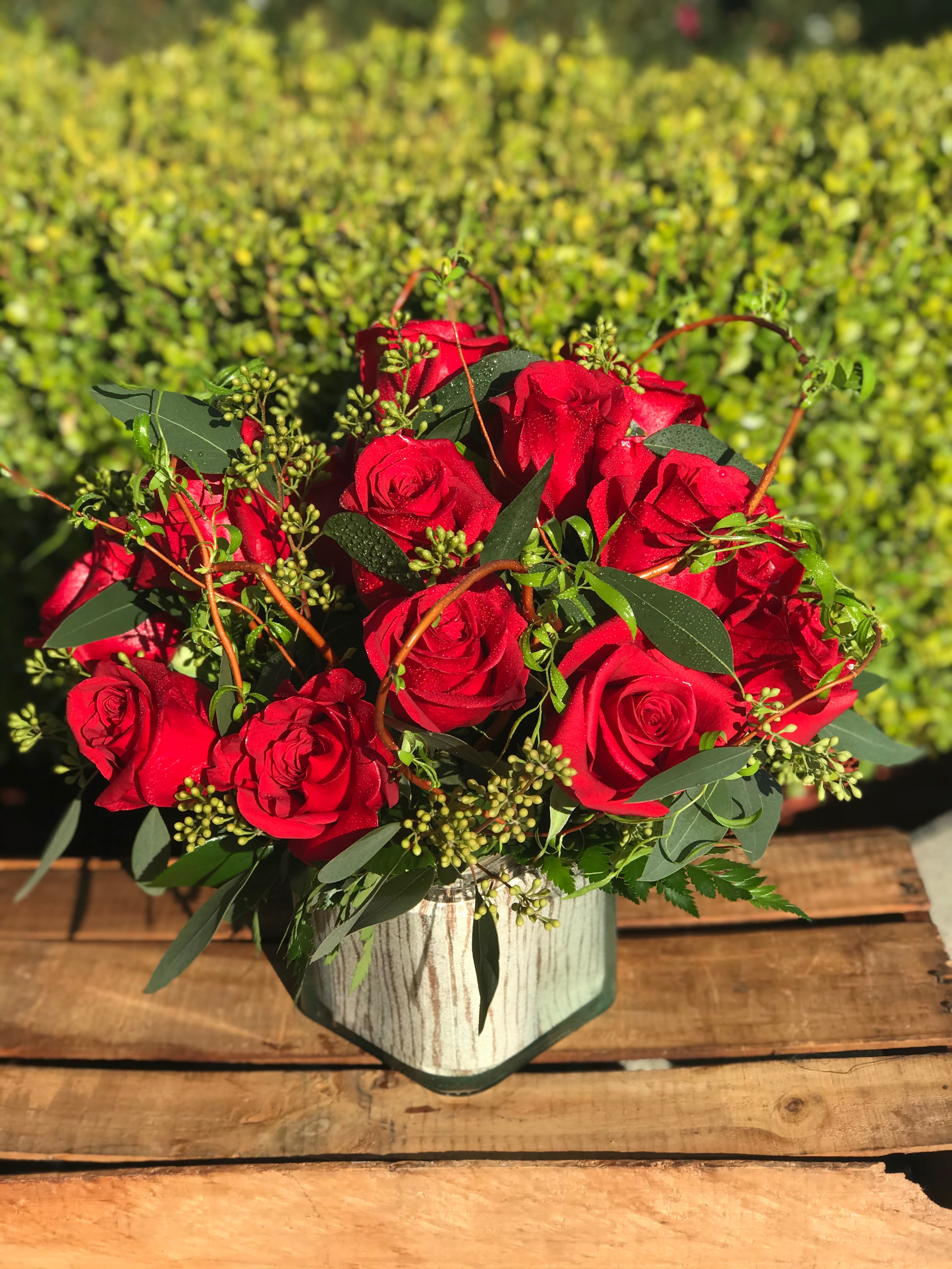 you always have My Heart - Red roses will brighten anyone's Valentines day. 18 dazzling red roses, accented with eucalyptus are overflowing out of a glass cube. Can be made in any color upon request.