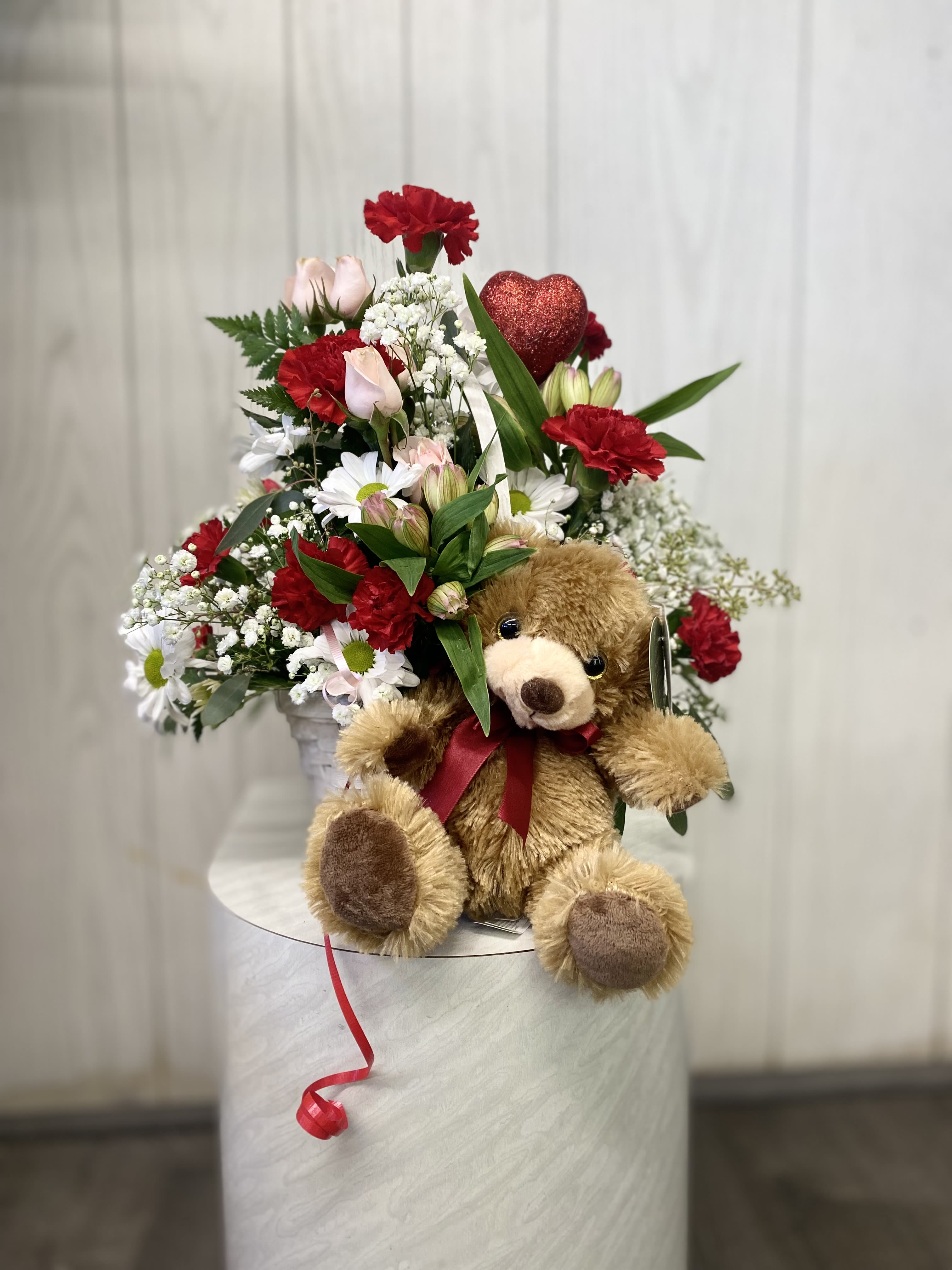 I Love You Beary Much Basket Arrangement - Two Gifts in One! Surprise your special someone with a charming mixed Valentine arrangement in a beautiful basket, paired with an adorable plush bear. Standing approximately 15 inches tall, this delightful duo is the perfect way to share love and joy. Please note that substitutions may occur based on floral availability, but we always ensure the overall look, feel, and value remain just as beautiful!