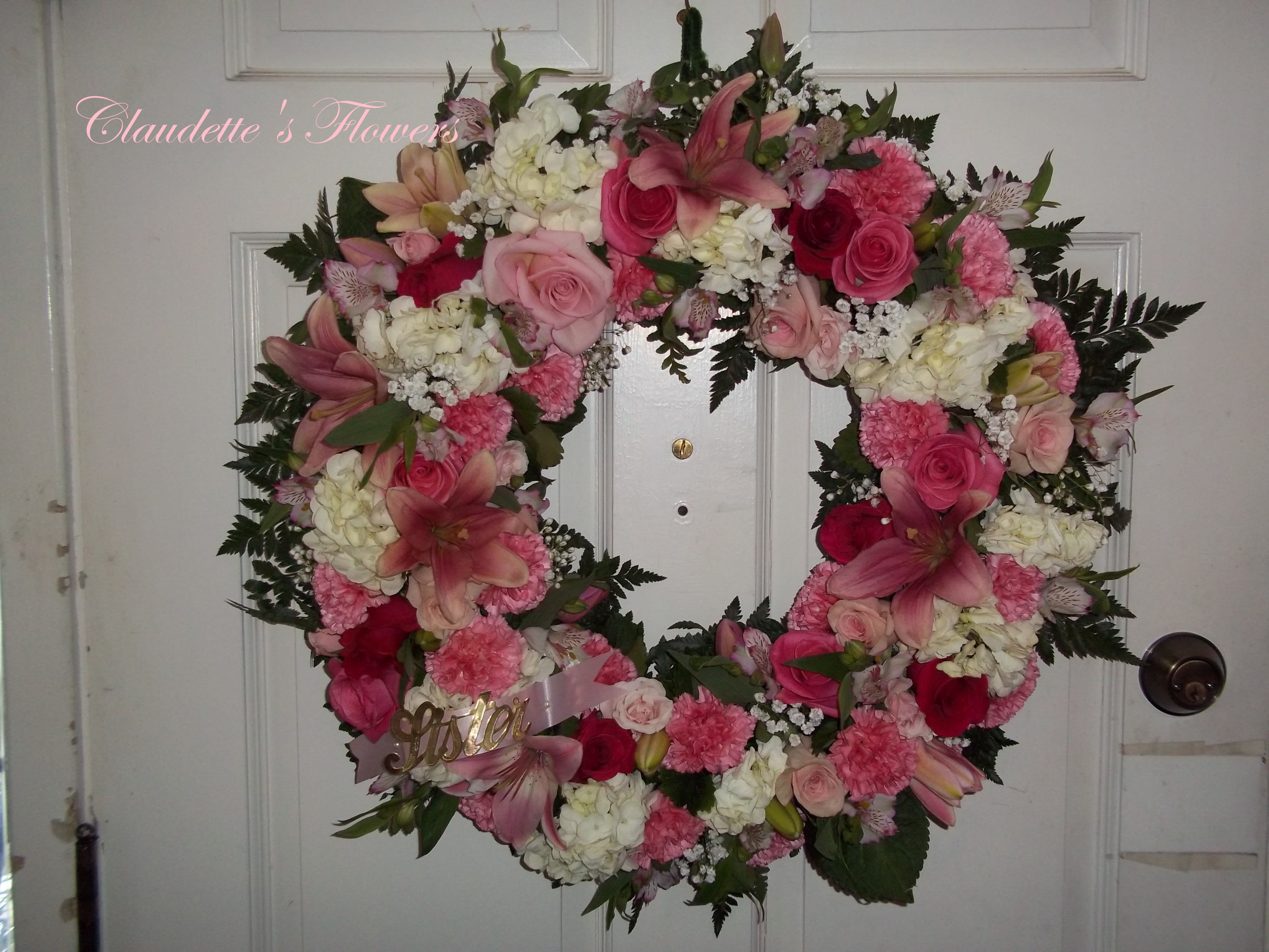 Pink Remembrance Wreath - Various shades of pink flowers with touches of white make this a stunning wreath for you loved one.