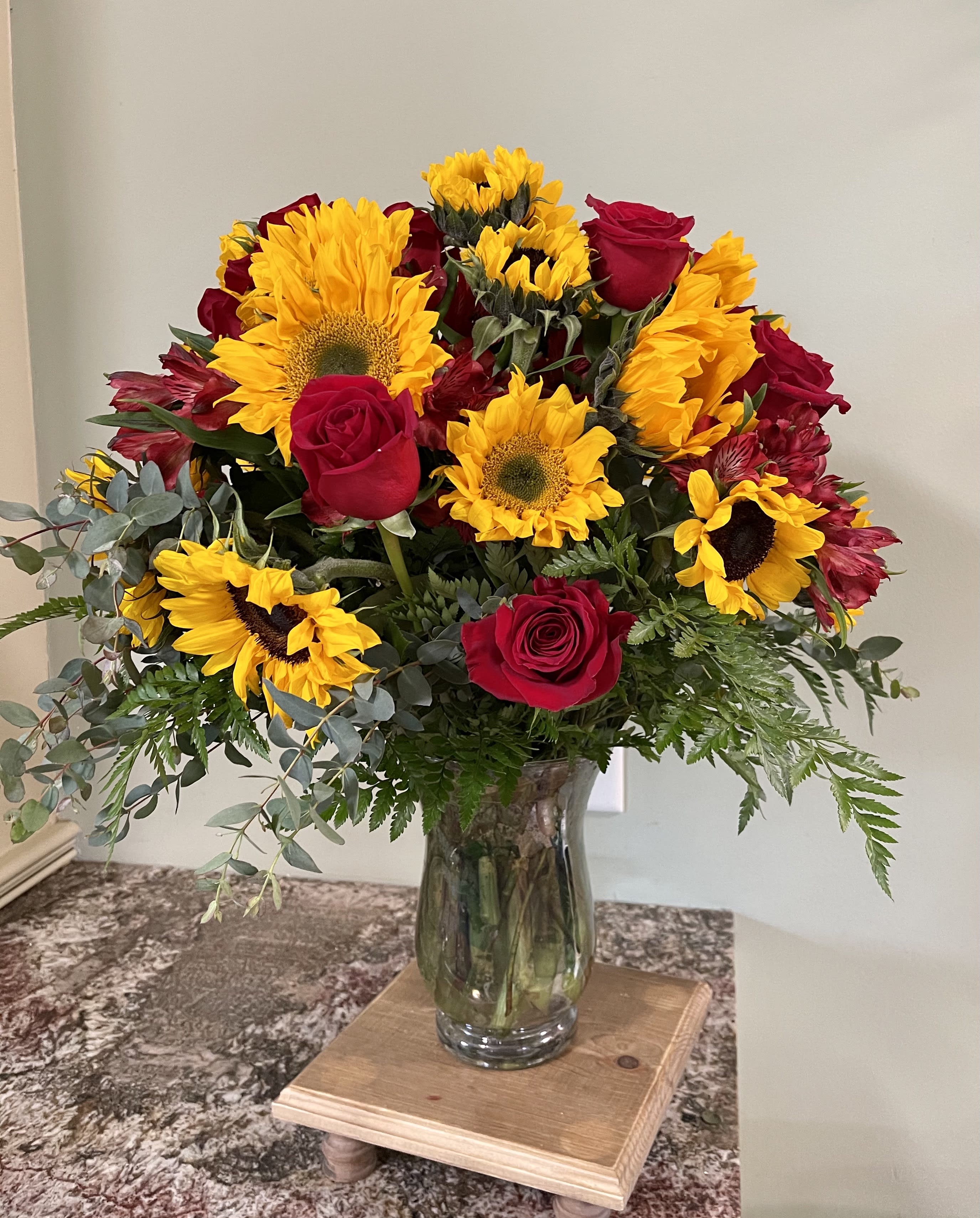 The Legacy Sunflower Delight - This floral creation of sunflowers and red roses is sure to delight.  Designed to your specifications with the colors your desire to compliment the sunflowers and delivered to your door!