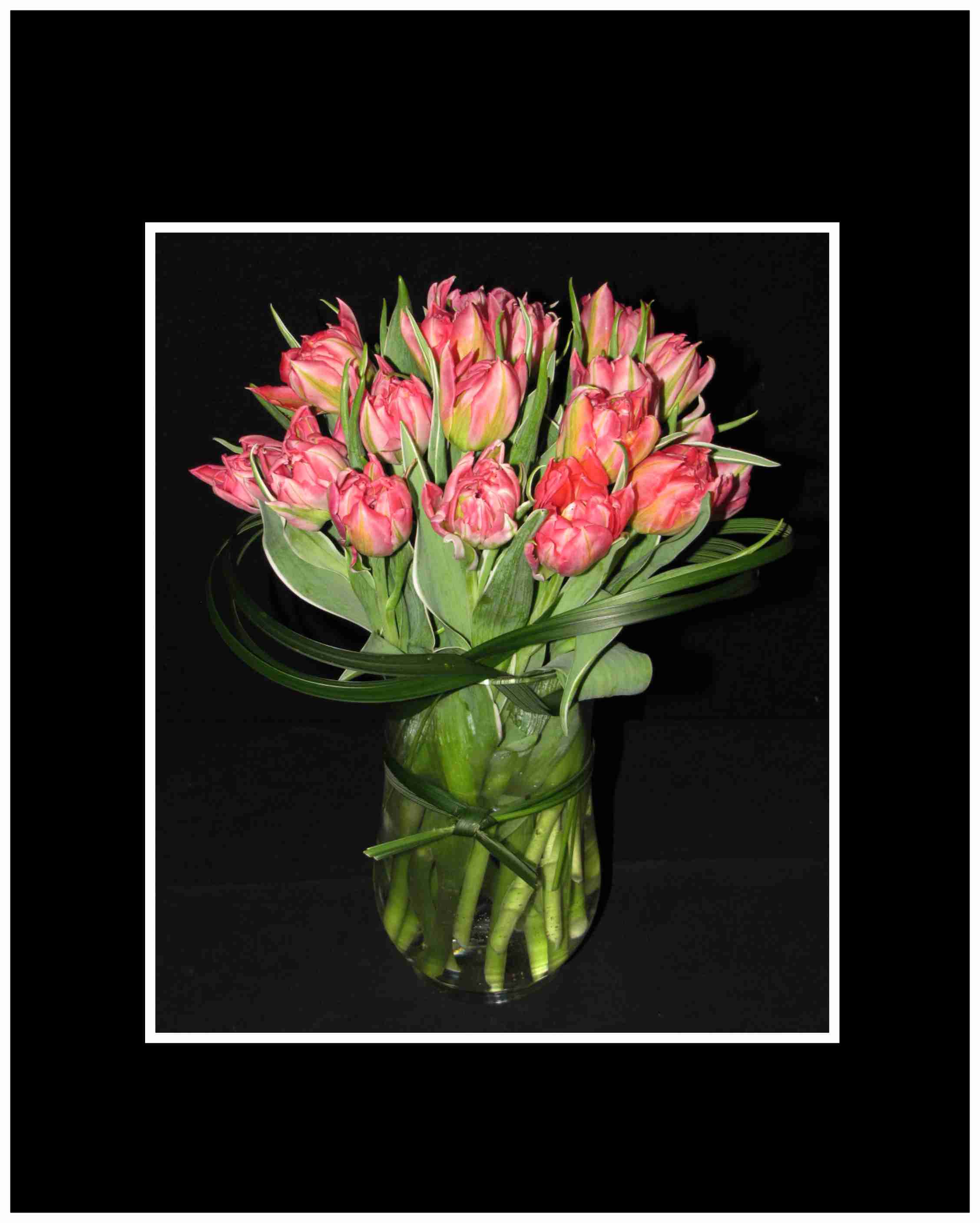For the Love of Tulips Bouquet - If they love spring, send a Vase of tulips, this arrangement is full and with the gathering vase we tie grasses in an around the arrangement.  Special Note we use the colors in stock at the time so call us if you want a specific color of tulips  Aprox 12" x 10"