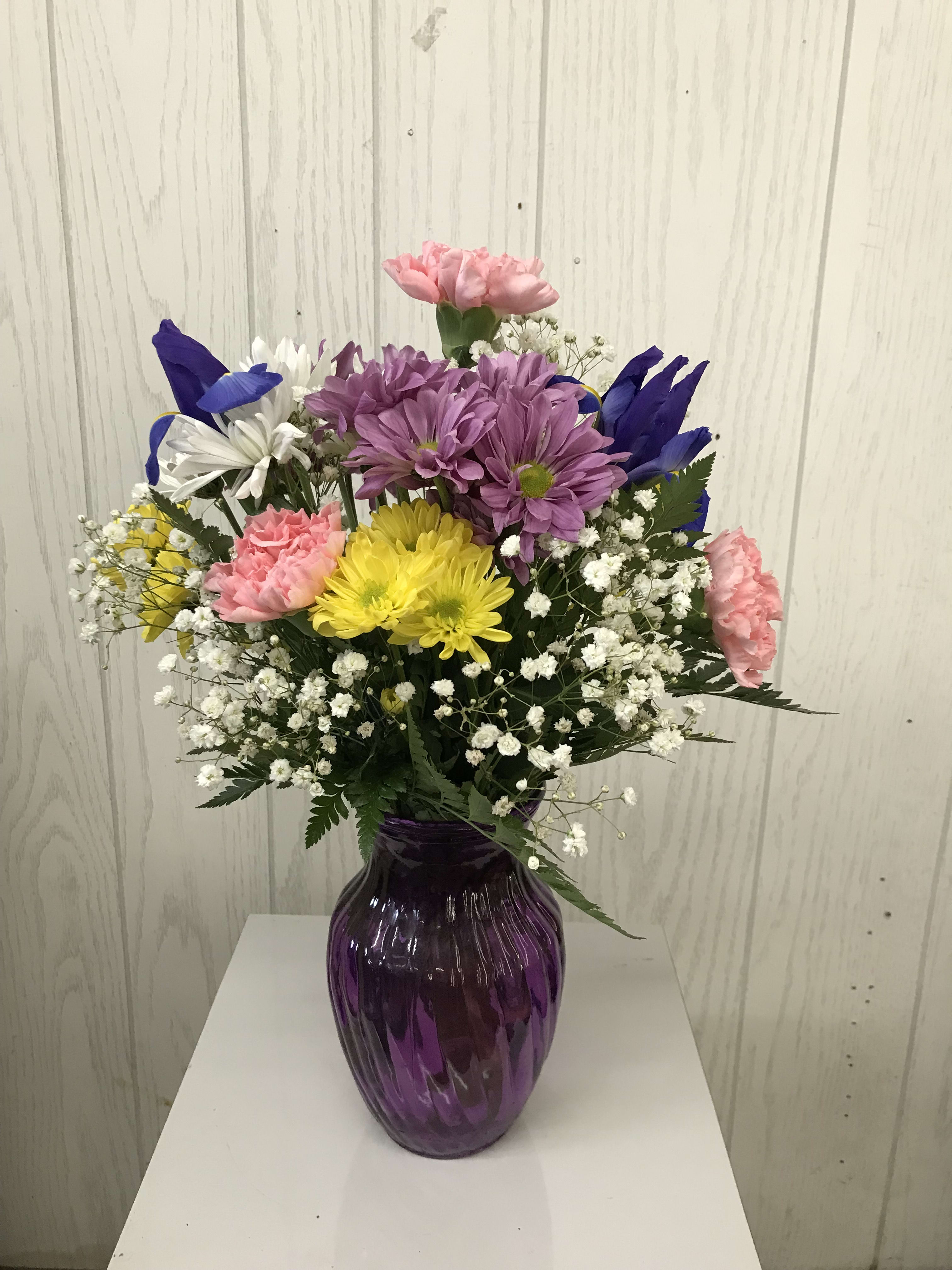 Spring Mix - Send spring wishes with this 'Designer's Choice' mix of spring colors. Our designers will pick the best blooms based on our floral inventory. Color and flowers may vary based on inventory. Approx. 13 inches high. Deluxe and premium have more flowers. 