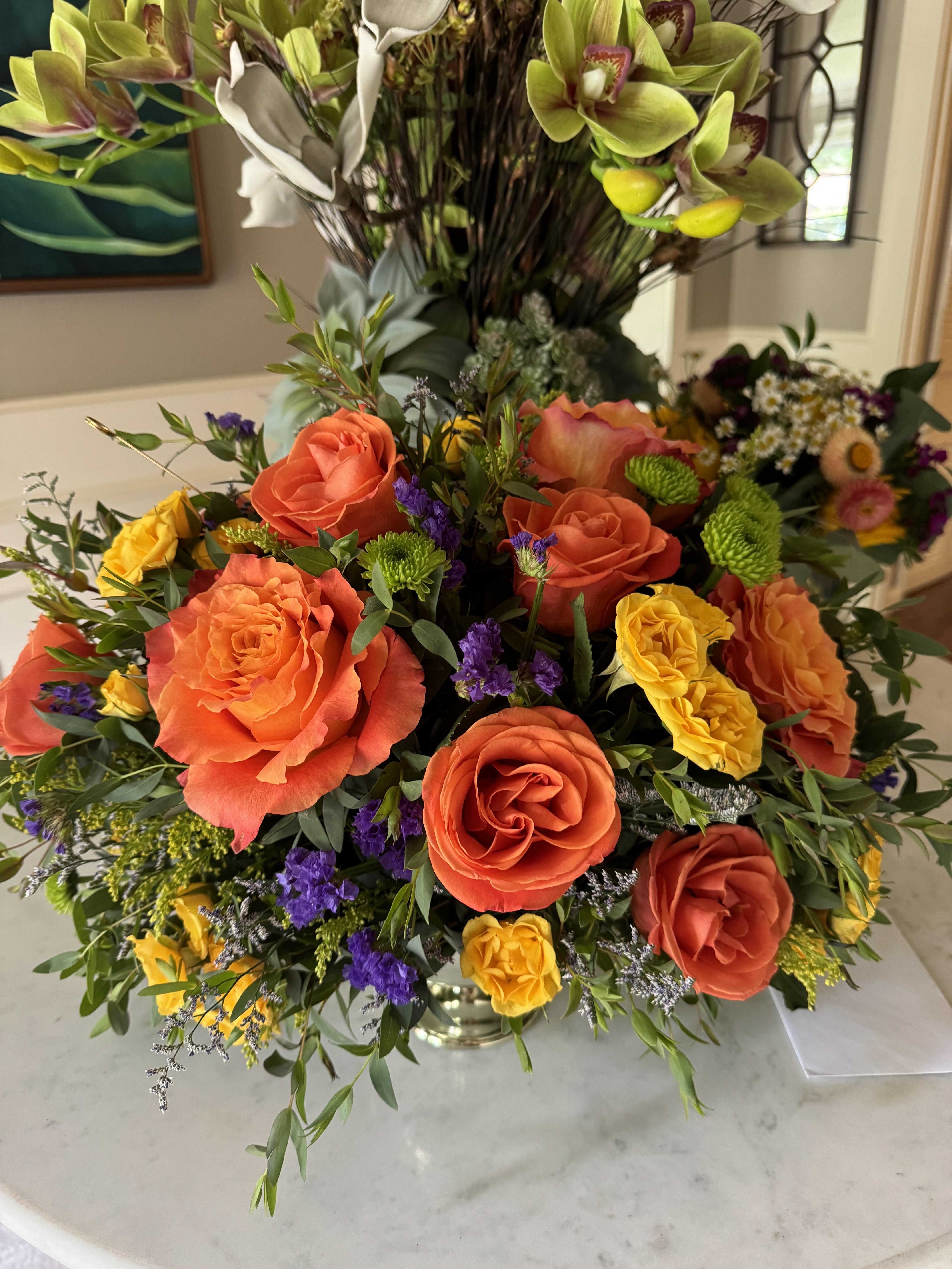 Cover Me in Sunshine - An elegant mix of large free spirit roses, pops of soft orange, deep purple statice, chrysanthemums, and southern belle yellow spray roses