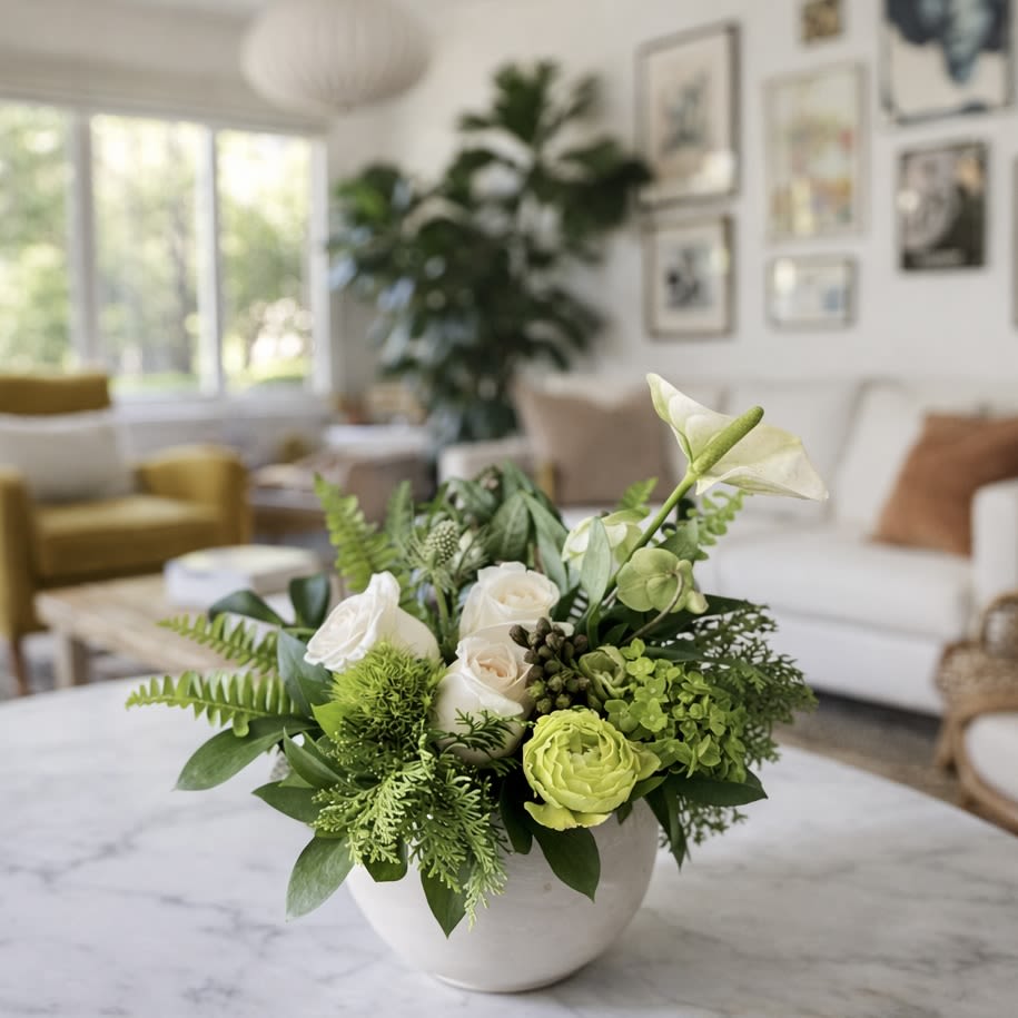 Sage - Sage is a calming, modern floral arrangement inspired by effortless California living and organic BoHo design. Designed in a smooth white ceramic vessel, this arrangement features a serene blend of creamy white roses, fresh green ranunculus, soft hydrangea accents, seasonal anthurium, and lush textural greenery. The palette is clean, airy, and naturally grounding—perfect for elevating any space with understated elegance.  Styled to feel at home on a sun-lit coffee table in a vintage Hollywood–inspired Silver Lake living room, Sage brings warmth, balance, and quiet sophistication. Its organic shape and fresh greens make it ideal for modern homes, thoughtful gifts, housewarmings, or moments when simplicity speaks volumes.  Whether you’re sending comfort, celebrating a new beginning, or adding a refined touch to your own space, Sage is a timeless choice that blends seamlessly with modern BoHo, coastal, and organic interiors.  Details:  Fresh white roses, green ranunculus, hydrangea, anthurium &amp; seasonal greenery  Designed in a modern white ceramic vase  Soft green and cream color palette  Organic, low-profile silhouette  Perfect for living rooms, coffee tables, offices, and gifting  Why You’ll Love It:  Neutral and versatile for any décor  Calming, fresh, and sophisticated