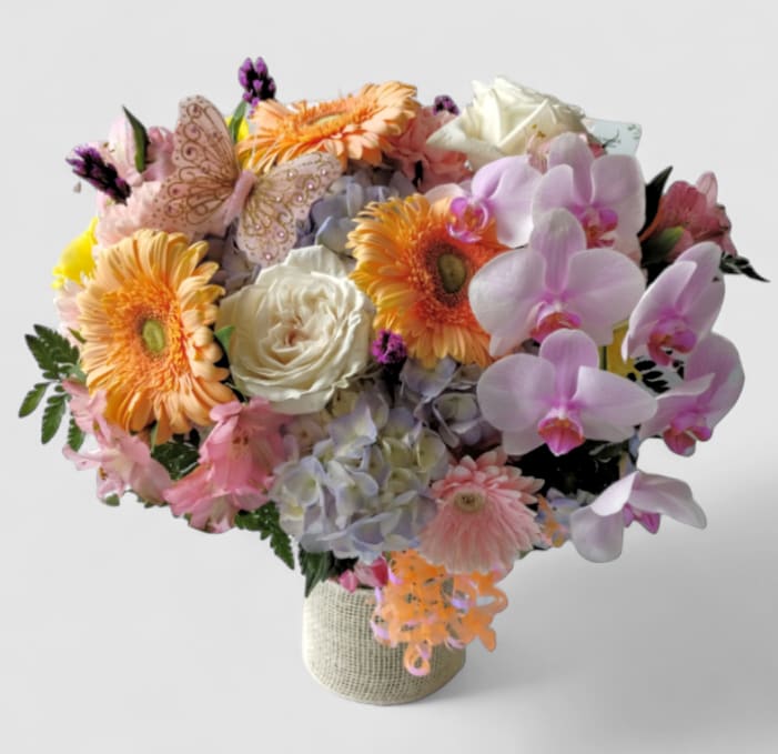 Feminine Fragrant Bella Beautiful Bouquet Designer's Choice - Lovely roses orchids and so much more arranged in a tall modern glass cylinder vase wrapped in beautiful white jute ribbon. Perfect to send for every occasion to show them how much you care. All fresh flower bouquets that leave my flower shop studio are beautiful one of a kind works of art made special and unique each time. Please visit my beautiful gallery to see my latest designs that I have created for my online customers. Send them happiness today.