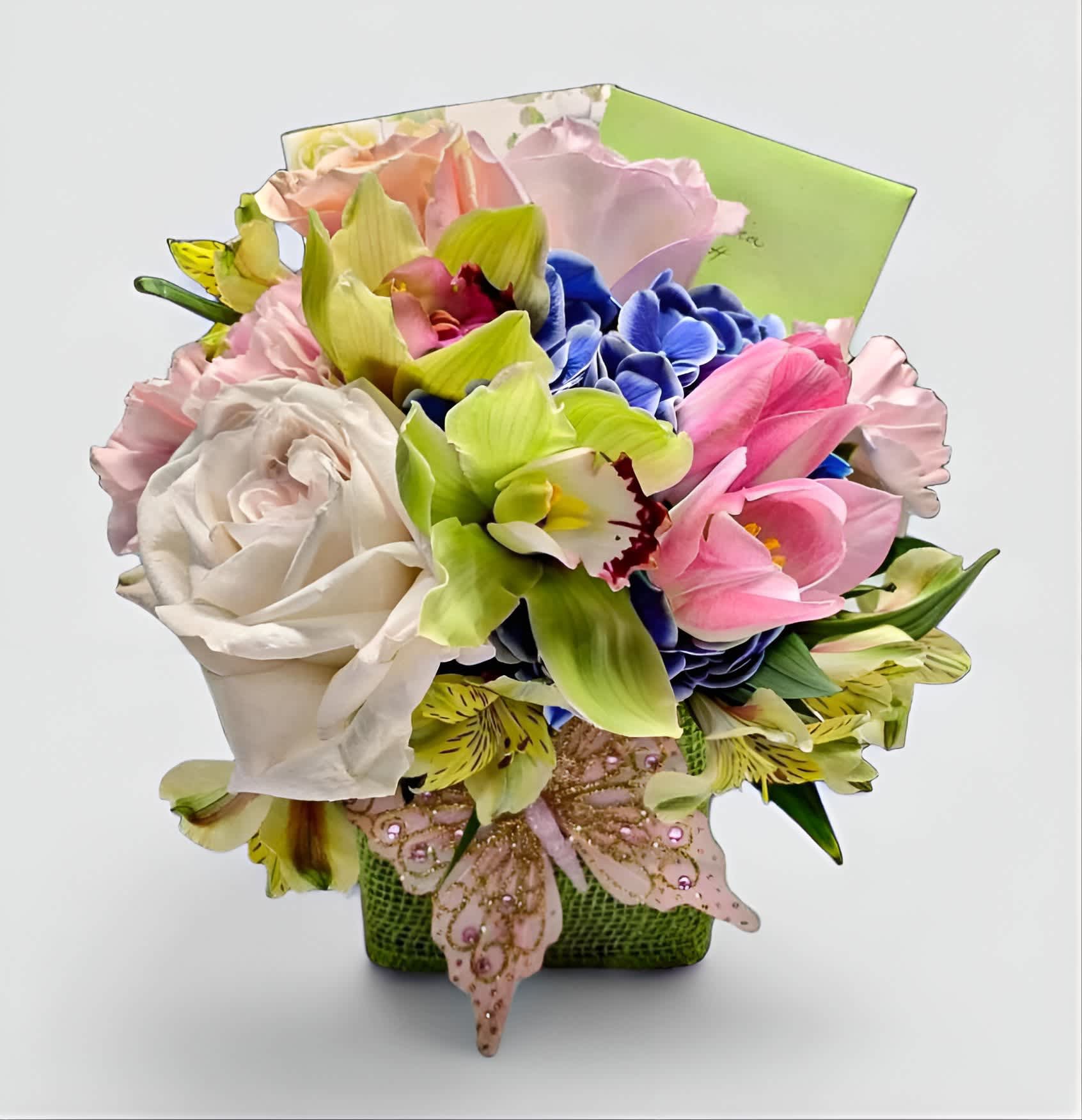 Congratulations Bouquet Designer's Choice - Roses orchids and more arranged in a modern glass cube vase wrapped in citrus green burlap ribbon adorned with a pretty butterfly. Perfect to send today to wish them a congratulations. Always made unique and extra special each and every time. Send them a beautiful congratulations.