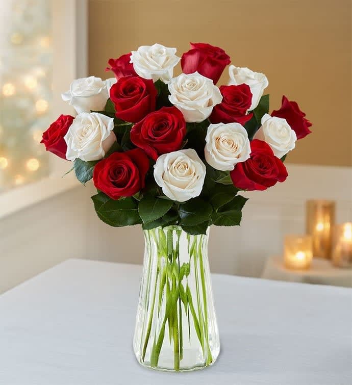 2 DOZEN RED AND WHITE ROSES - Love's divine, and roses are too. This beautiful mix of red and white roses, (2 Dozen) is a timeless gift for your beloved. 