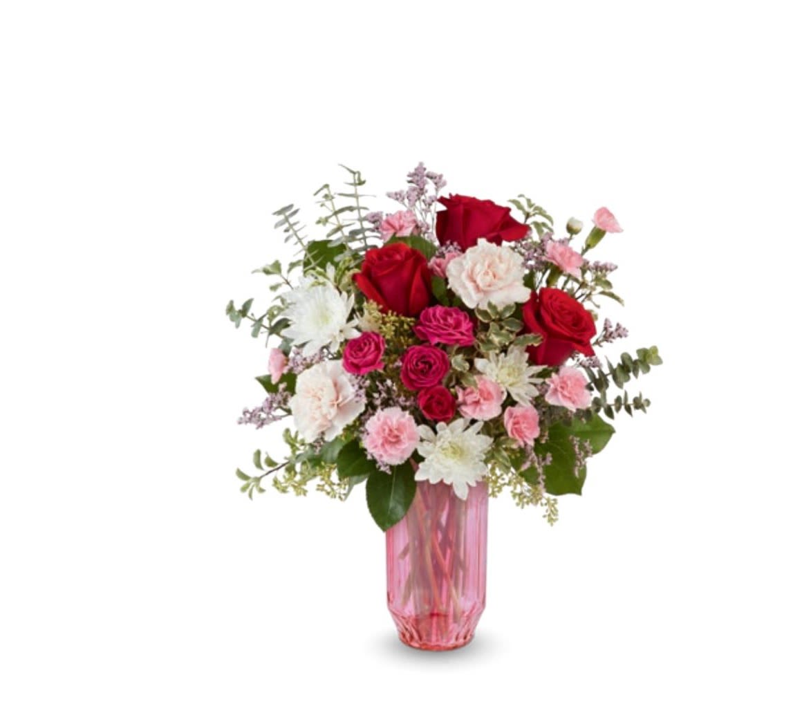Gorgeous Gem - This pink vase holds a variety of flowers and colors, red roses, hot pink spray roses, white mums, assorted euc, pink mini carns and standard white carns