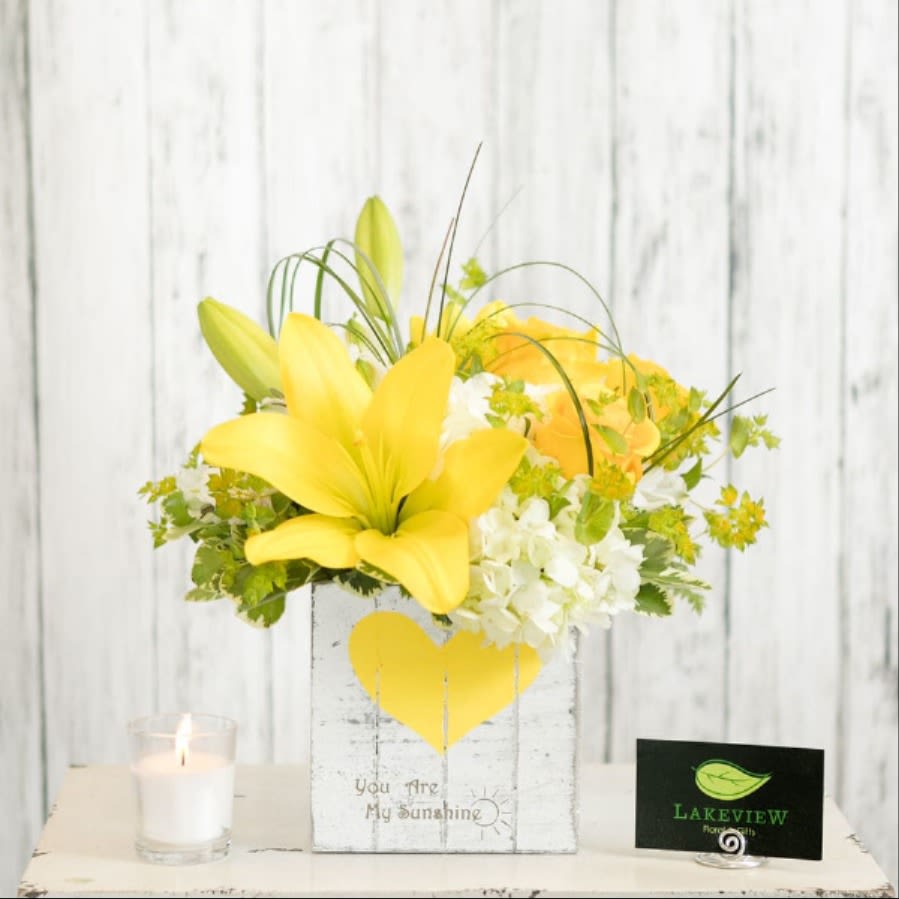 Sunbeam  - Celebrate a loved one with joyous yellow and white blooms, within a wooden whitewashed cube container.    Approximate Dimensions: 12" H x 10" W