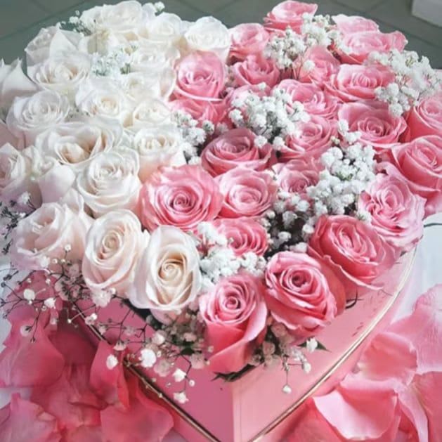 Rosanna Heart Box-Pink &amp; White Roses - A heart full of love — radiant and sparkling hot pink and delicate Vendela white roses, surrounded by baby breath beautifully arranged to express what words cannot. The perfect gift to say “I Love you” or "Happy Anniversary", today and always. Approximately 30-35 rose stems in a pink heart shaped floral box, wrapped in a pink satin ribbon and bow.