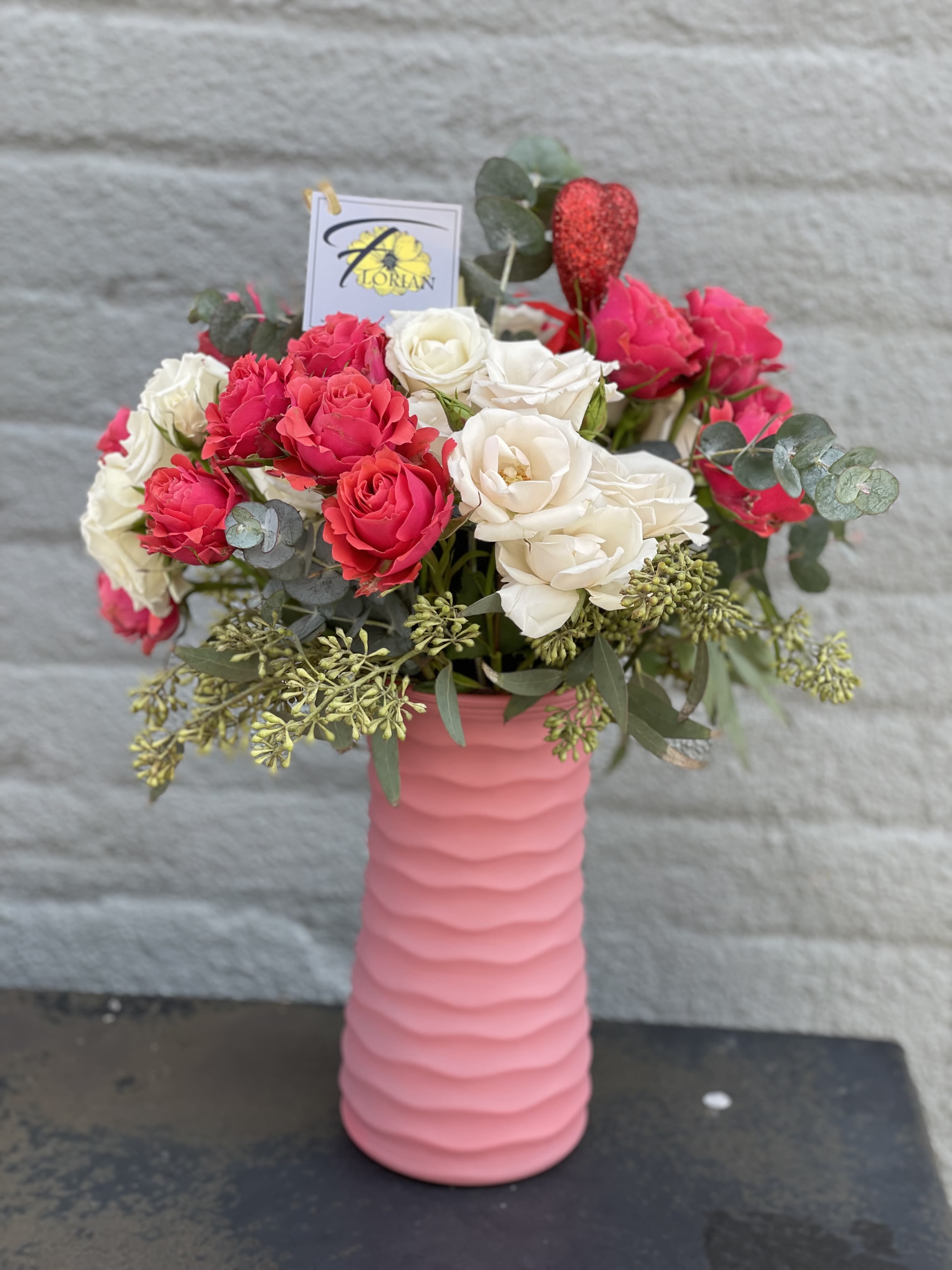 Be Mine - Want to go a little different this year than your standard dozen roses? This is the answer! A stunning blend of specialty spray roses in cerise and cream tones are sure to make your Valentine never forget you. AVAILABLE for Valentine's Week Only!
