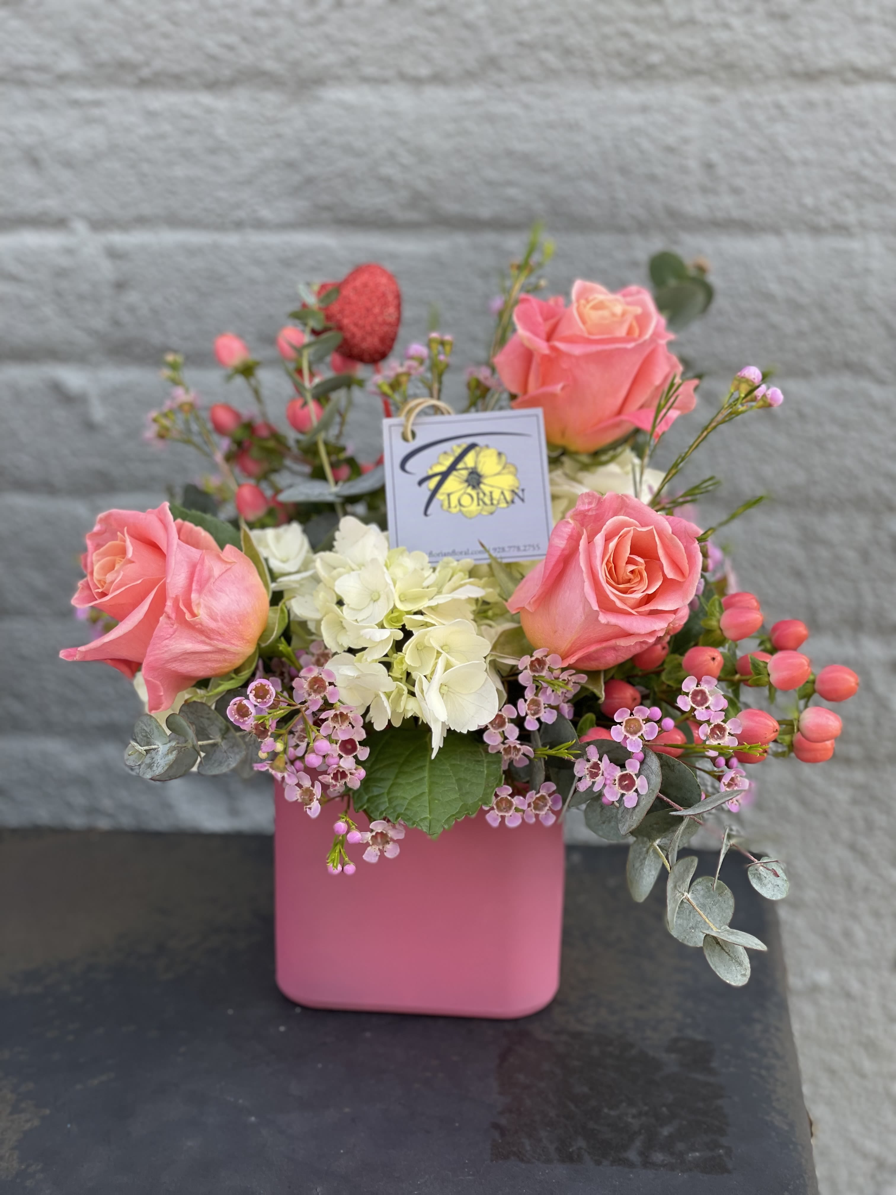 Love...Simply - This arrangement just simply exudes a sweet love for your Valentine! Perfect for mom, sister, grandma or to let your crush know you're swooning over them. Roses, Hydrangea and more come in a pretty in pink cube. AVAILABLE for Valentine's Week Only!