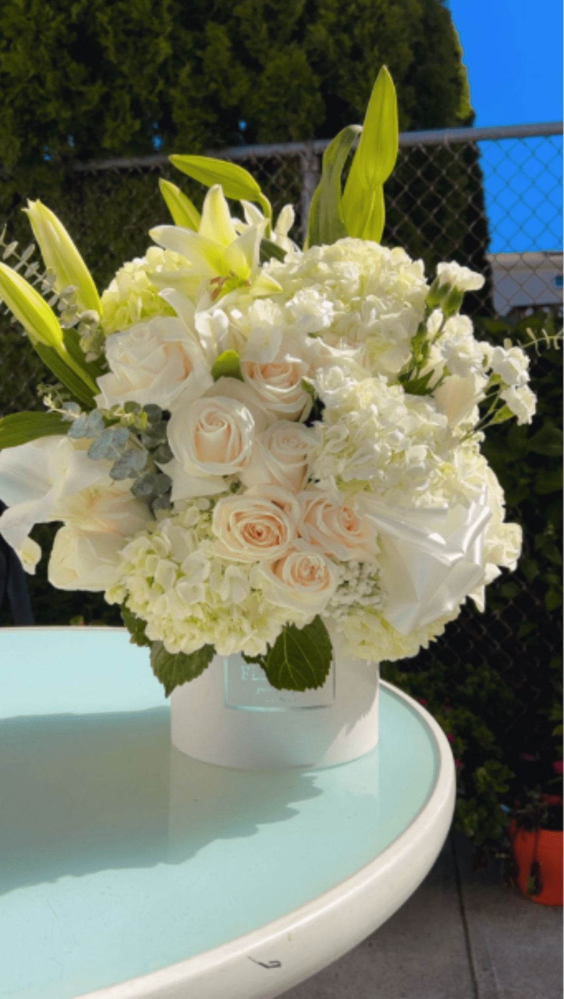 Luxury White Elegance Sympathy Flower Box  - A peaceful arrangement featuring white lilies, hydrangeas, carnations and roses — designed to express comfort, love, and remembrance during difficult times. Perfect for sending heartfelt sympathy condolences and honoring a beautiful life.