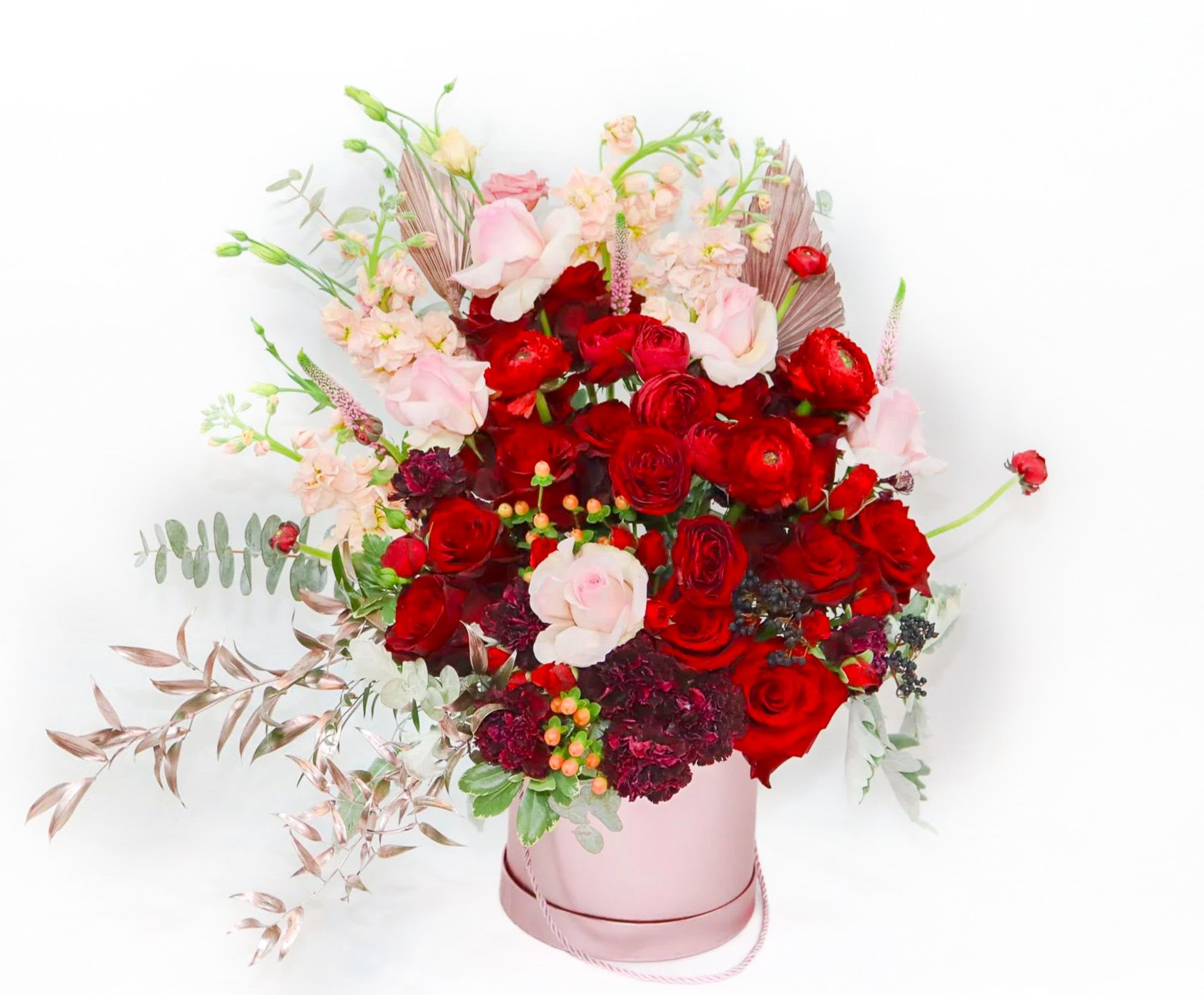 My Valentine -  My Valentine   A timeless declaration of love  Turn hearts instantly with My Valentine, a breathtaking arrangement designed to express passion, romance, and devotion. Overflowing with luxurious red roses, soft blush blooms, and rich seasonal textures, this elegant hatbox arrangement is a true celebration of love in its most beautiful form.  Set in a soft pink keepsake box and artfully styled with cascading greenery and delicate floral accents, My Valentine blends classic romance with modern sophistication. Every detail is thoughtfully curated to create a bold yet tender statement — perfect for when only the most unforgettable gesture will do.  Perfect for:     •    Valentine’s Day     •    Anniversaries     •    Romantic surprises     •    Luxury gifting   Why it’s unforgettable:     •    Premium red and blush roses symbolizing love and devotion     •    Expertly hand-arranged for a full, luxurious look     •    Elegant hatbox design — no vase required     •    Designed to make an instant emotional impact  Size: Large hatbox arrangement Care: Add fresh water to the floral foam every 1–2 days to maintain freshness  Please note: Flower varieties may vary slightly due to seasonal availability, but the rich red and soft blush color palette and overall luxurious style will always be maintained.   My Valentine is more than flowers — it’s a moment, a memory, and a promise wrapped in petals. 