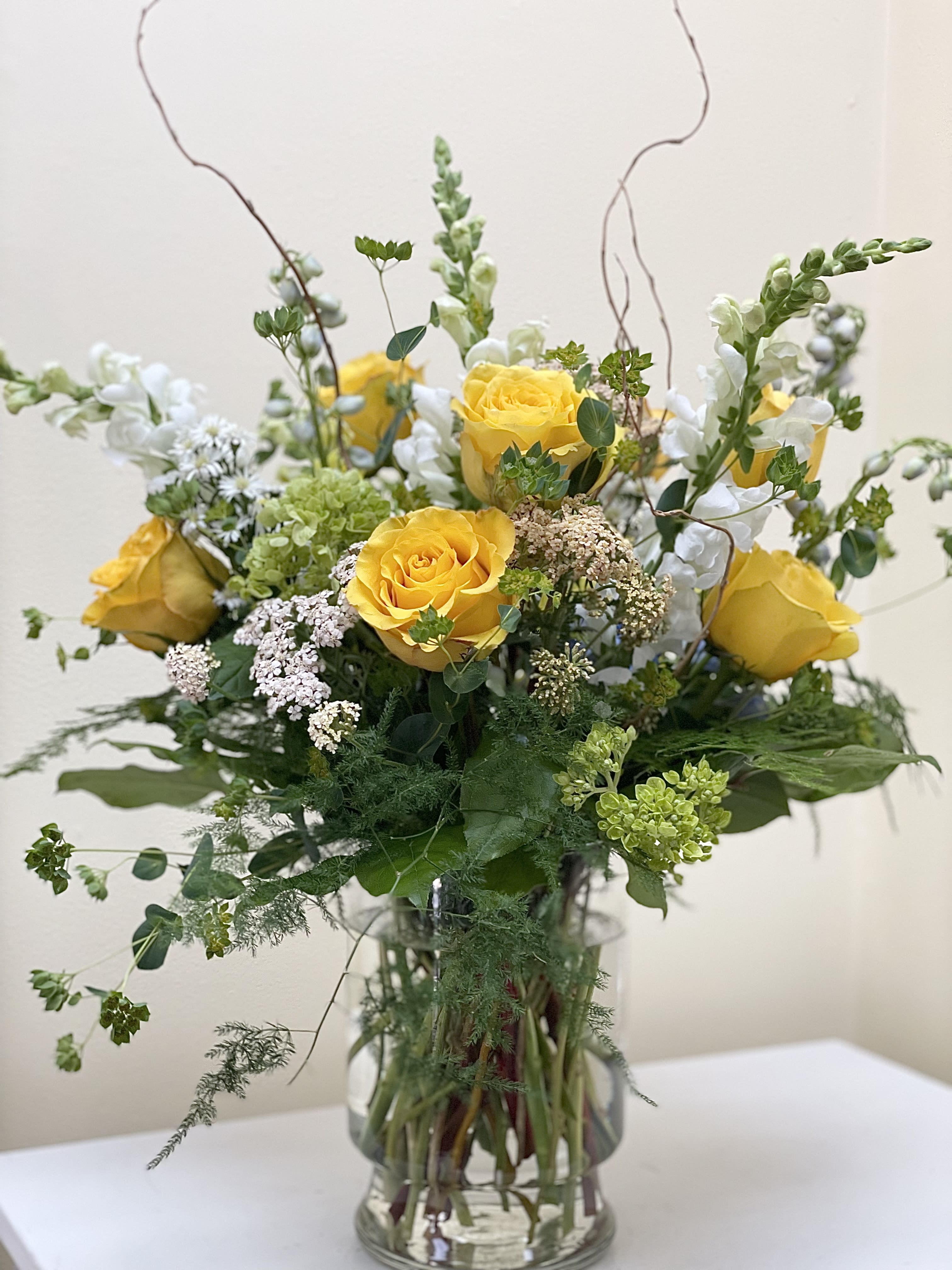 Garden of Yellow - A yellow, green and white arrangement of seasonal blooms and textural elements, tall and beautiful.