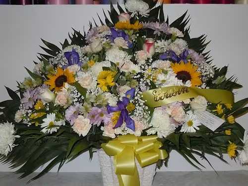 TB37 Traditional Basket - A mixture of white, lavender and yellow daisies, white roses tipped burgandy, white fuji mums, blue iris, pink carnations, baby's breath, greens and yellow bow  Banner - $15.00 + extra  Substitutions may apply due to flower availability