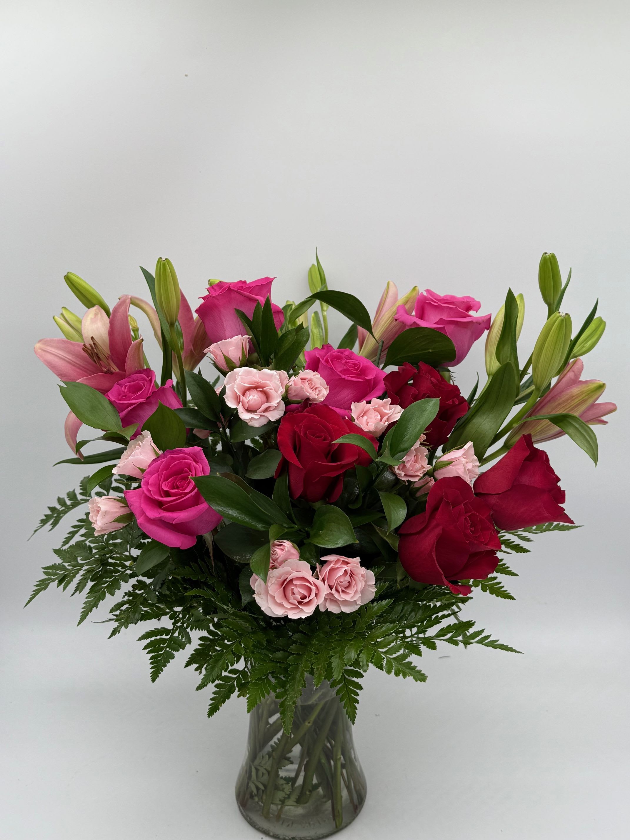 All My Love - A dreamy mix of passionate reds and sweet pink florals designed to express deep love and devotion. Arranged in a clear glass vase with lush greenery, this bouquet is perfect for moments that deserve more than just words. -Flower varieties and shades may vary.-