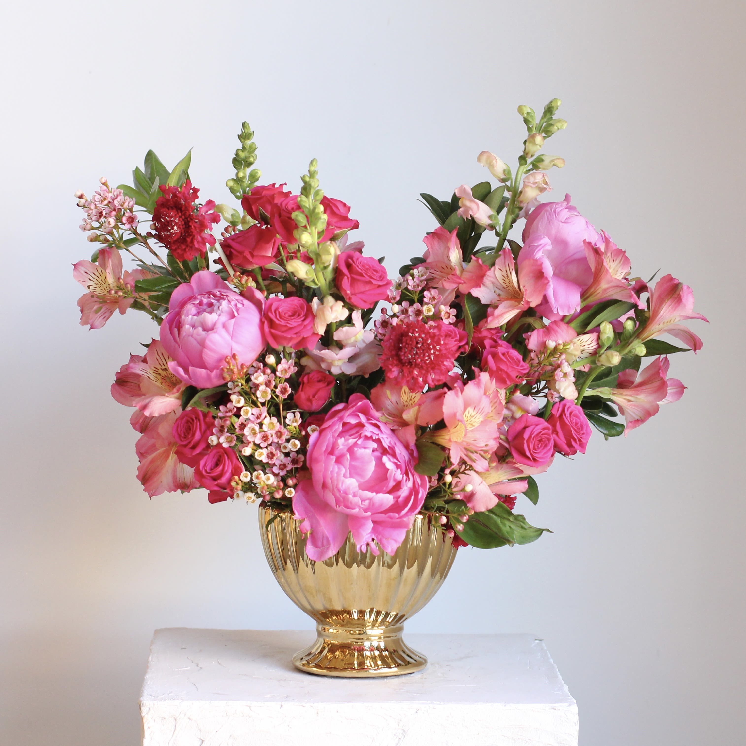 Pretty in Pink  - Say hello to our Pretty in Pink arrangement. A vibrant mix of hot pink and layered pink blooms designed in a luxe gold container. Bursting with rich pink tones and playful contrast, this cheerful design brings instant joy and elegance to any space. Perfect for celebrating, gifting, or simply brightening the day, Pretty in Pink is a sweet and stylish way to say you care.  Delivery Policy: At Middlemist, we aim to make every delivery seamless and delightful. It is the sender’s responsibility to ensure the recipient is available to accept delivery between 3–5pm on the scheduled date and that the delivery address is accurate. We will send a text notification to the recipient on the day of delivery. If no one is available to receive the order, it will be returned to the shop and may be picked up or redelivered for an additional delivery fee. If a recipient requests the order be left unattended, we cannot guarantee the condition of the flowers or plants, and no refunds will be issued once an order is left outside.