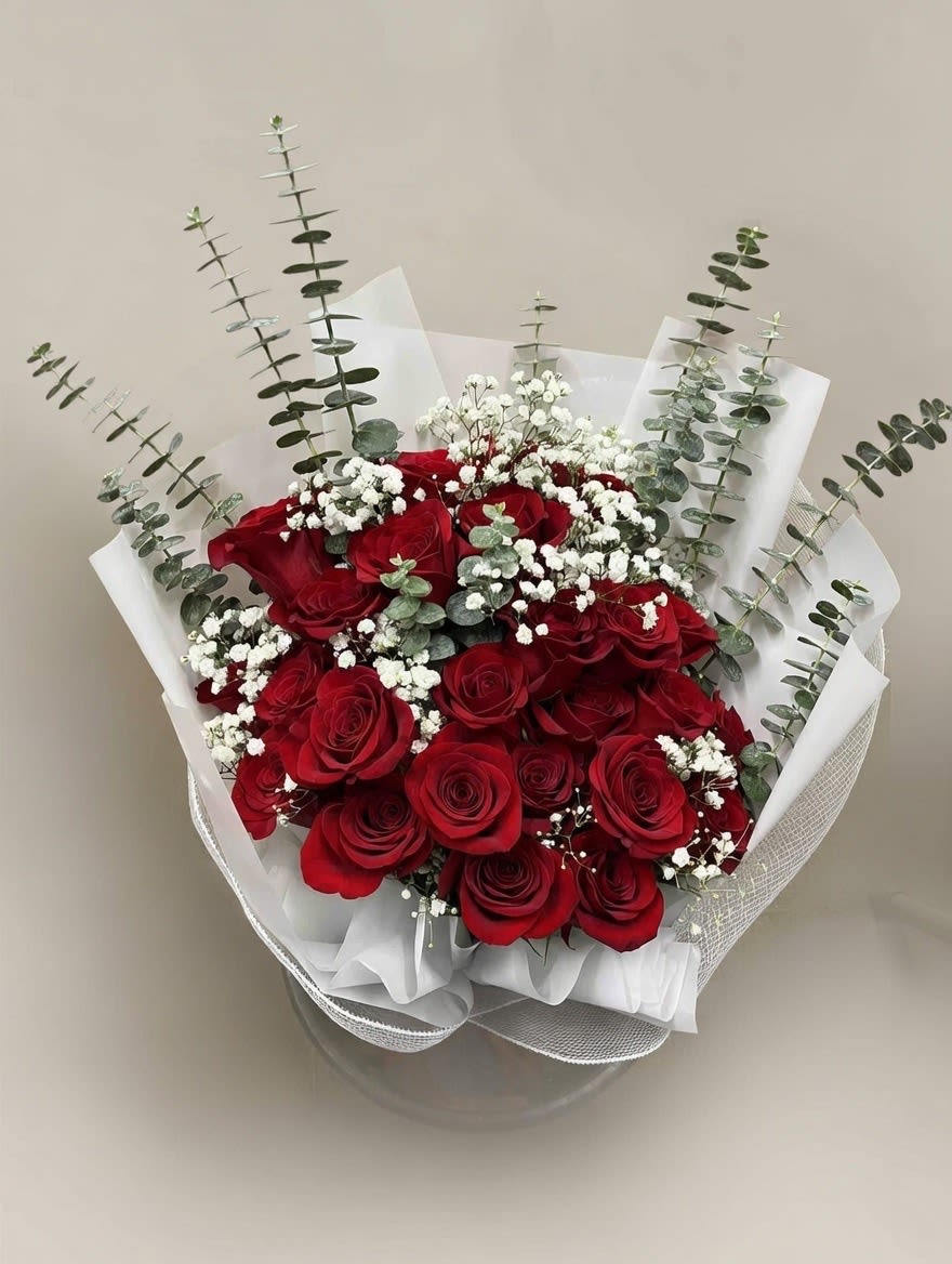Ruby Symphony - A bold, heartfelt symphony of premium red roses harmonized with white accents and fresh eucalyptus accents.
