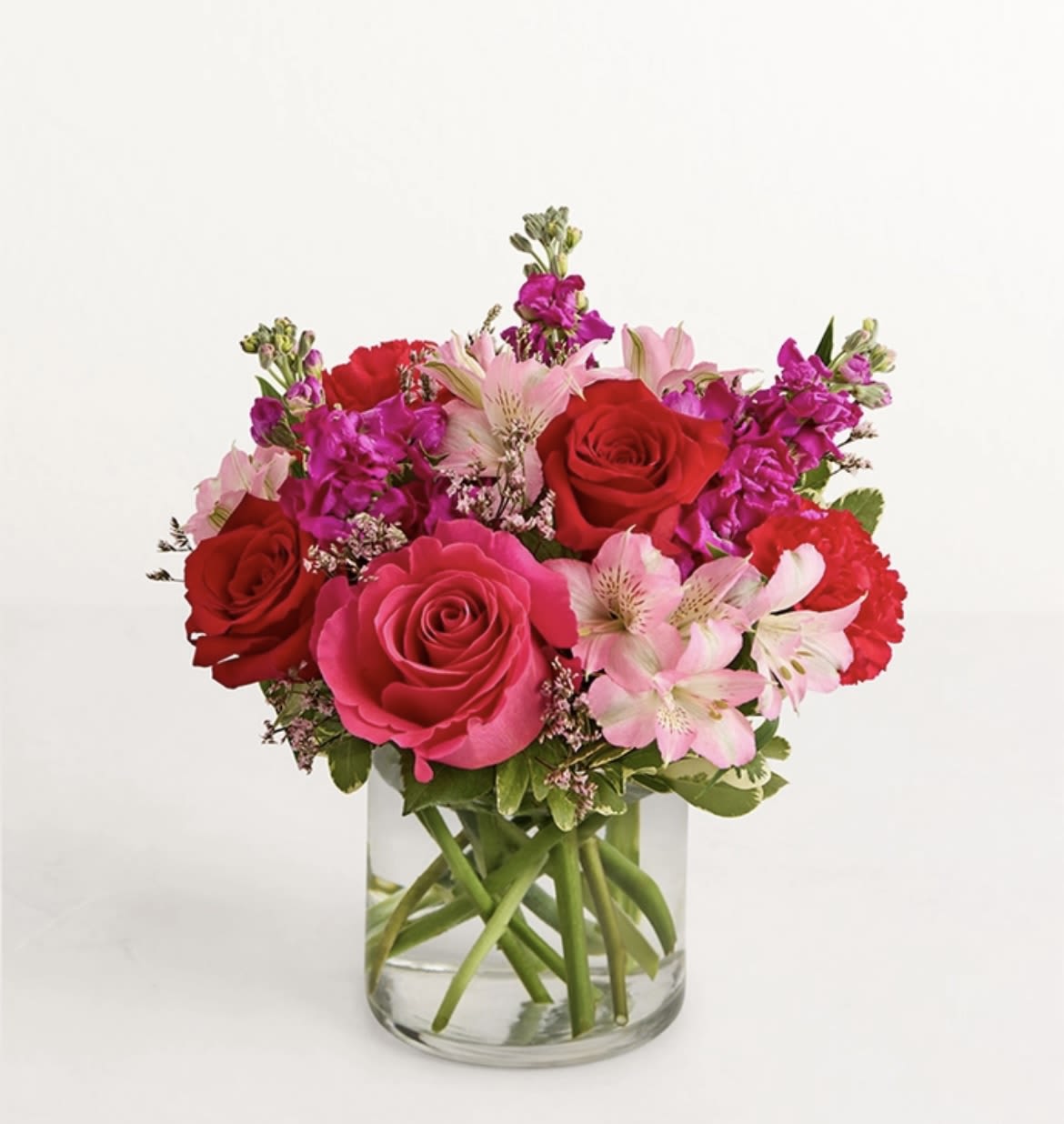 Fantasy bouquet - all-around arrangement reds and pinks, designed in a clear glass cylinder vase. standard/deluxe 5", premium 6" vase.