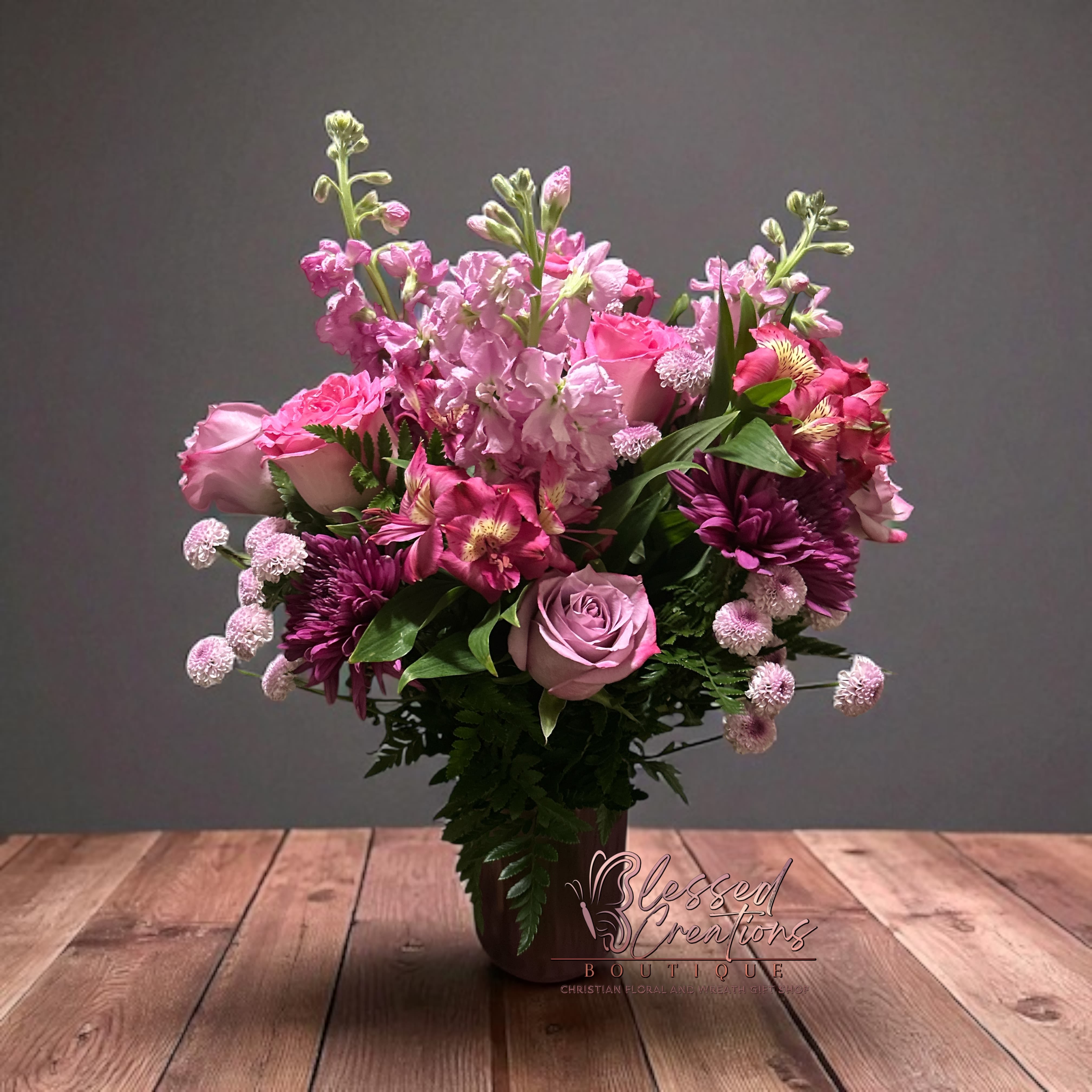 Pretty in pink  - Description: A graceful blend of lavender roses, pink stock, alstroemeria, mums, carnations, and filler blooms, accented with lush greenery. A romantic and feminine gift for birthdays, encouragement, or sympathy.