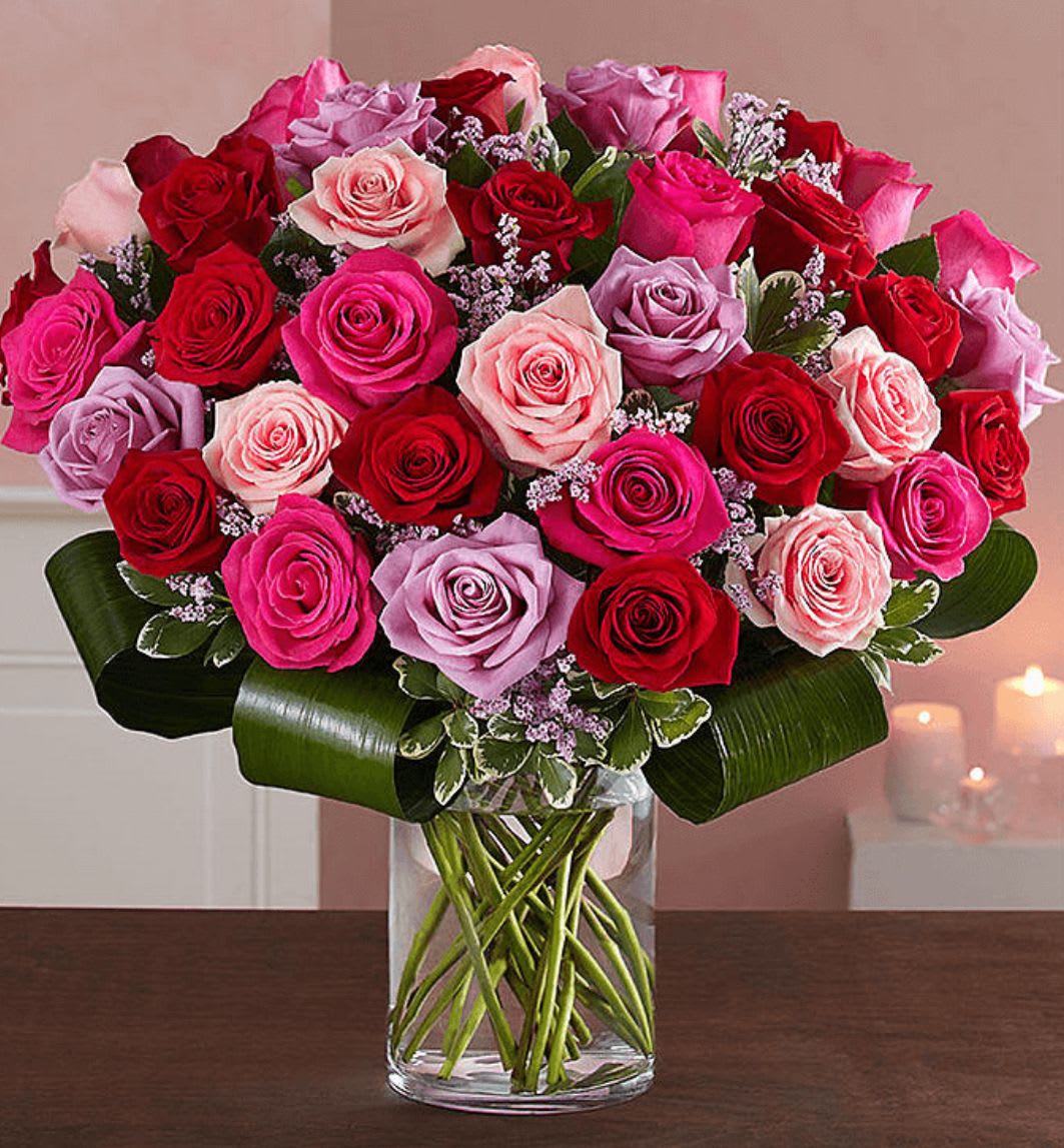 Forever Love - Let her know your love is forever with a sensational surprise she’ll remember forever! This arrangement includes 36 timeless roses in striking shades of red, pink and lavender inside a stylish vase for the ultimate romantic gesture. And because one amazing gift deserves another (and another…and another!)  The Standard bundle only includes the flower arrangement and vase. The Deluxe bundle includes a cuddly medium plush bear and box of chocolate. The Premium bundle includes a plush bear, chocolates, and three Valentine day Mylar balloons.