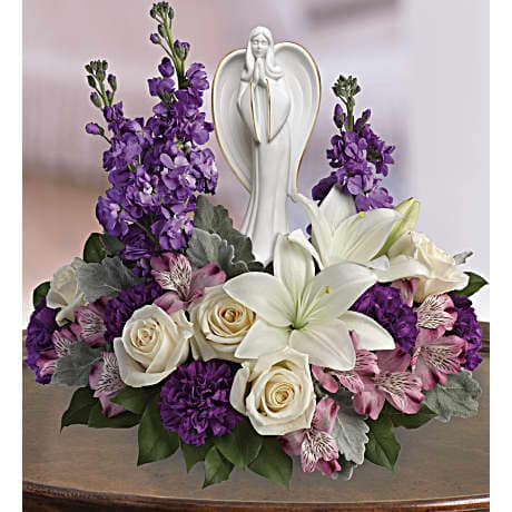 Beautiful Heart Bouquet - Show them they're in your heart with this magnificent display of roses, lilies and alstroemeria, gracefully surrounding a timeless angel sculpture keepsake. Beautifully fragrant, it's a tribute that will warm their hearts forever. This beautiful arrangement includes flowers such as  roses, white lilies, alstroemeria,carnations, stock, and lemon leaf. Delivered with Teleflora's Angel of Grace keepsake. Orientation: One-Sided